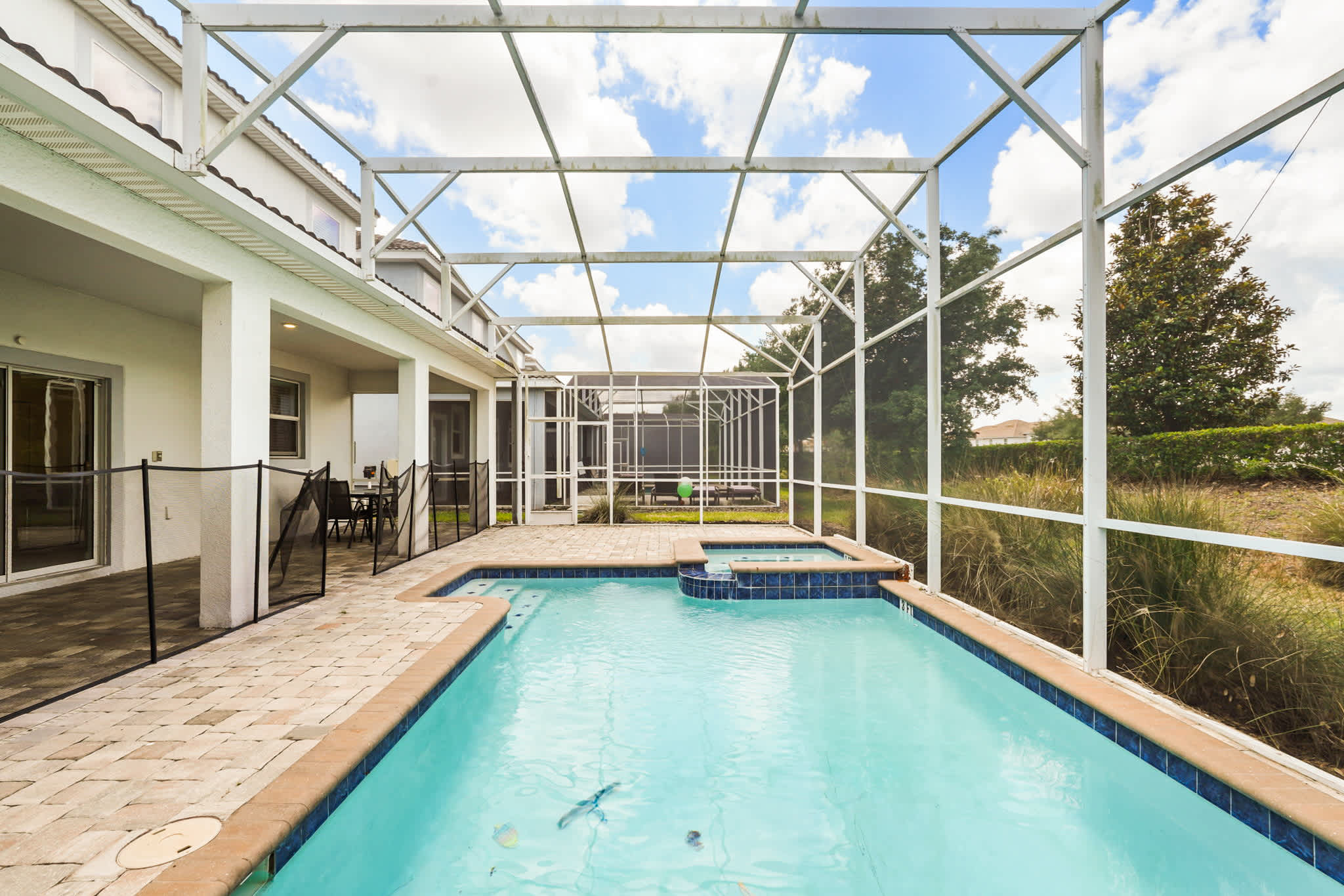 Enjoy a relaxing swim in your private screened pool and hot tub, perfect for family fun or a peaceful retreat.