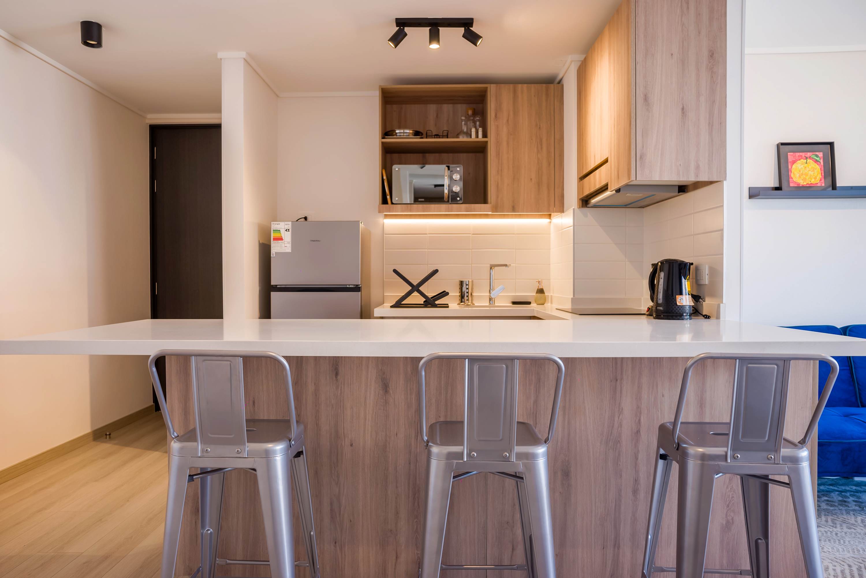 Chic and modern kitchen with stylish seating, perfect for enjoying a meal or a quick coffee break.