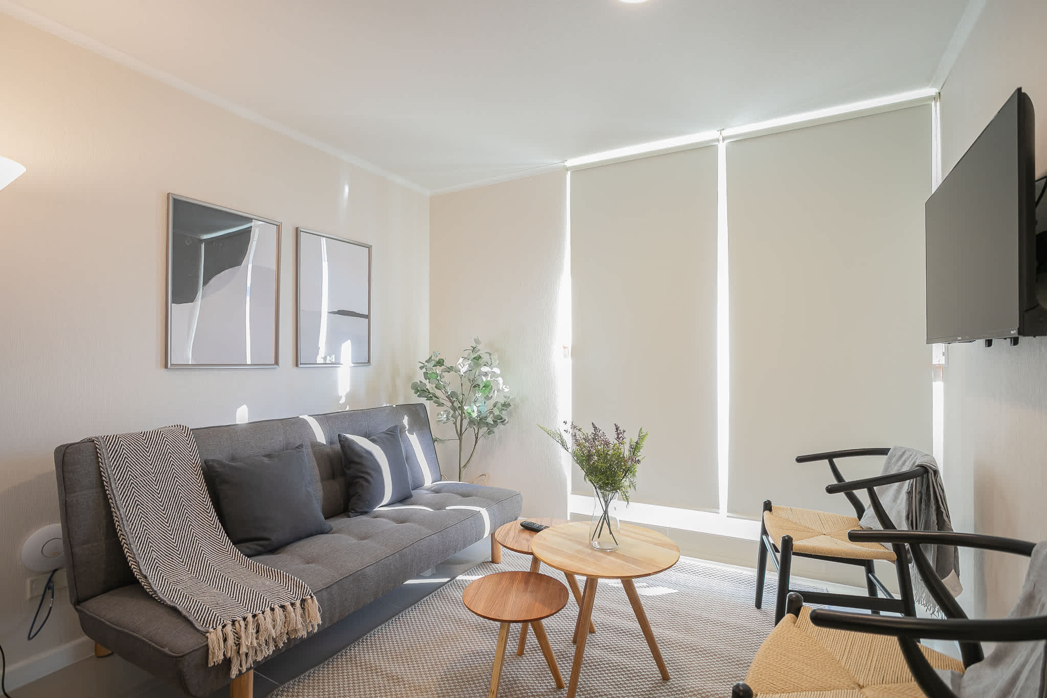 Relax in this stylish and cozy living room, featuring modern decor and a comfortable sofa, perfect for unwinding after a day exploring the city.