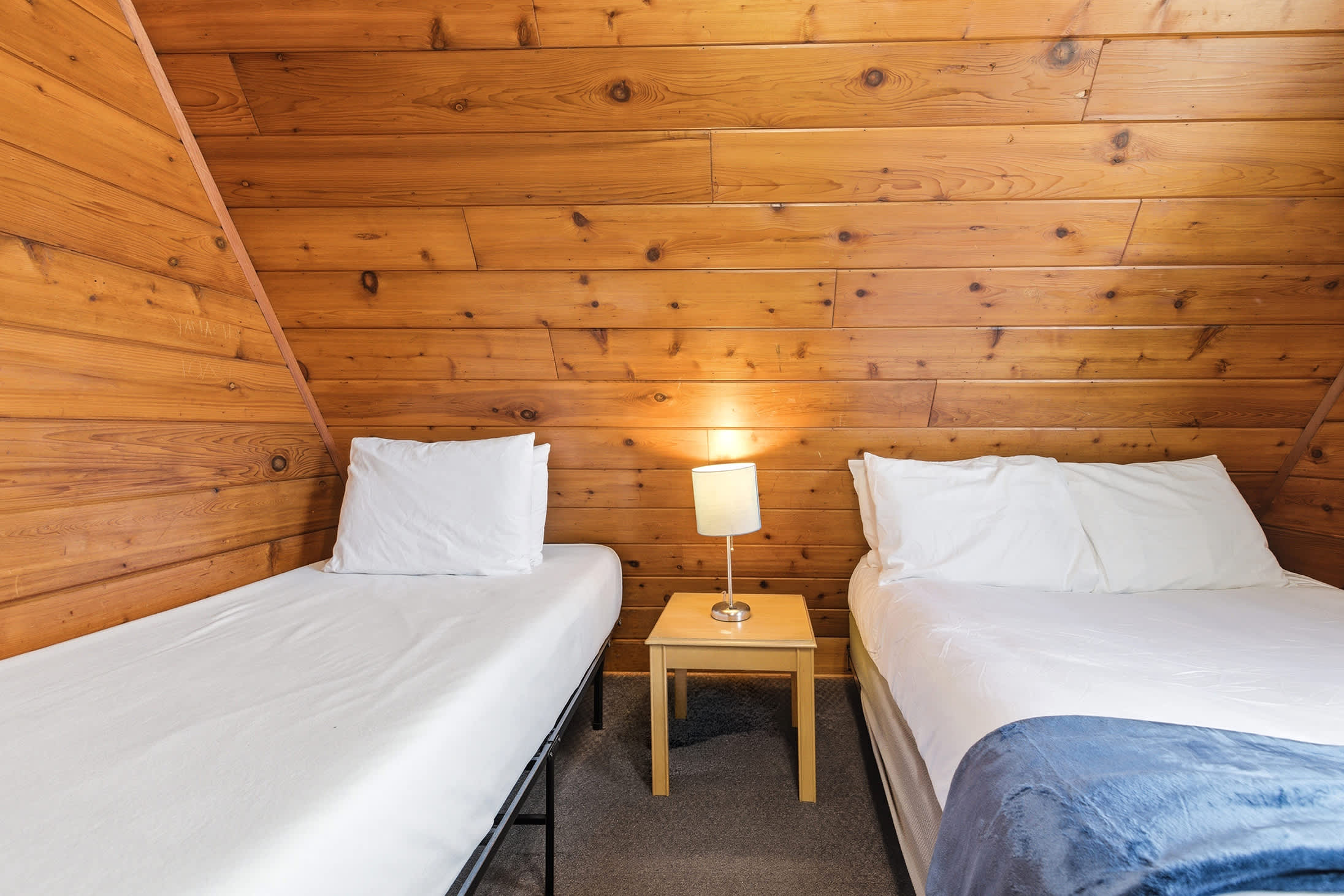 Cabin nights feel a little softer in this tucked-away sleeping space.