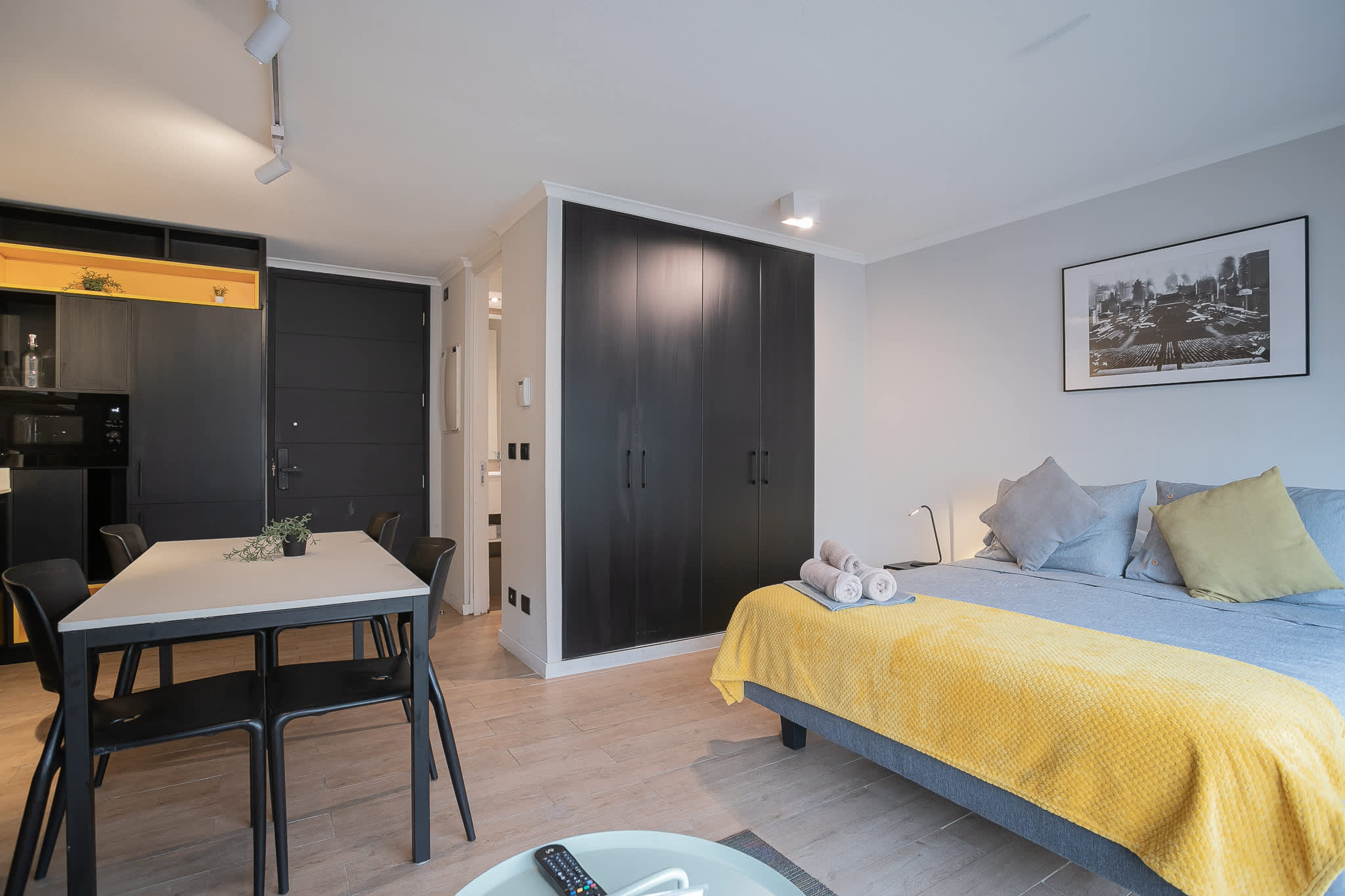 Cozy studio apartment with modern decor and a convenient dining area, perfect for a comfortable stay.