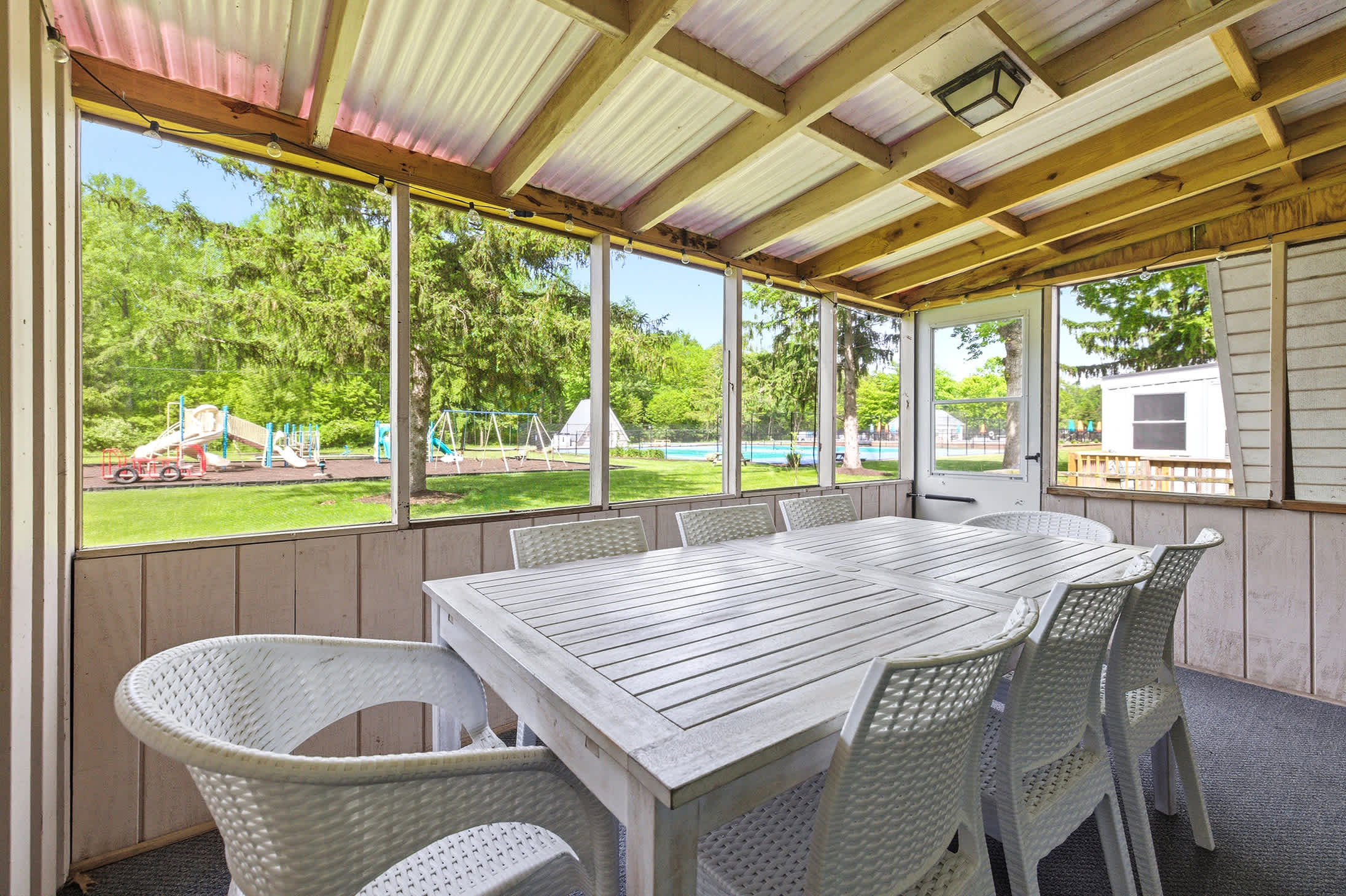 From the porch, you’re steps from pool days, playground fun, and lakeside memories.