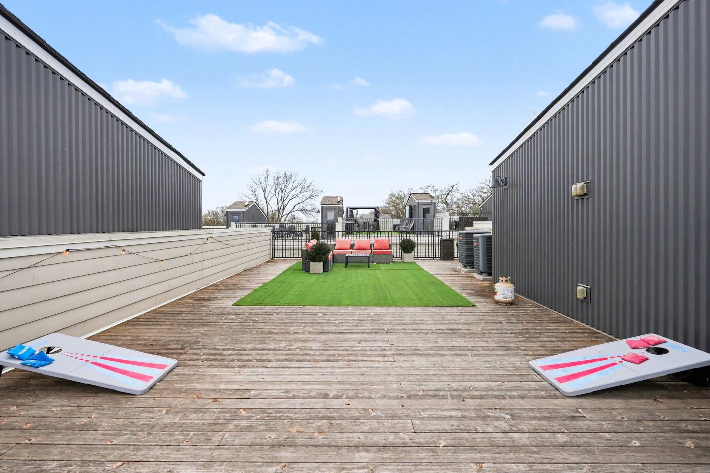 Rooftop patio with grill, corn hole, and views perfect for lounging. | Unit B