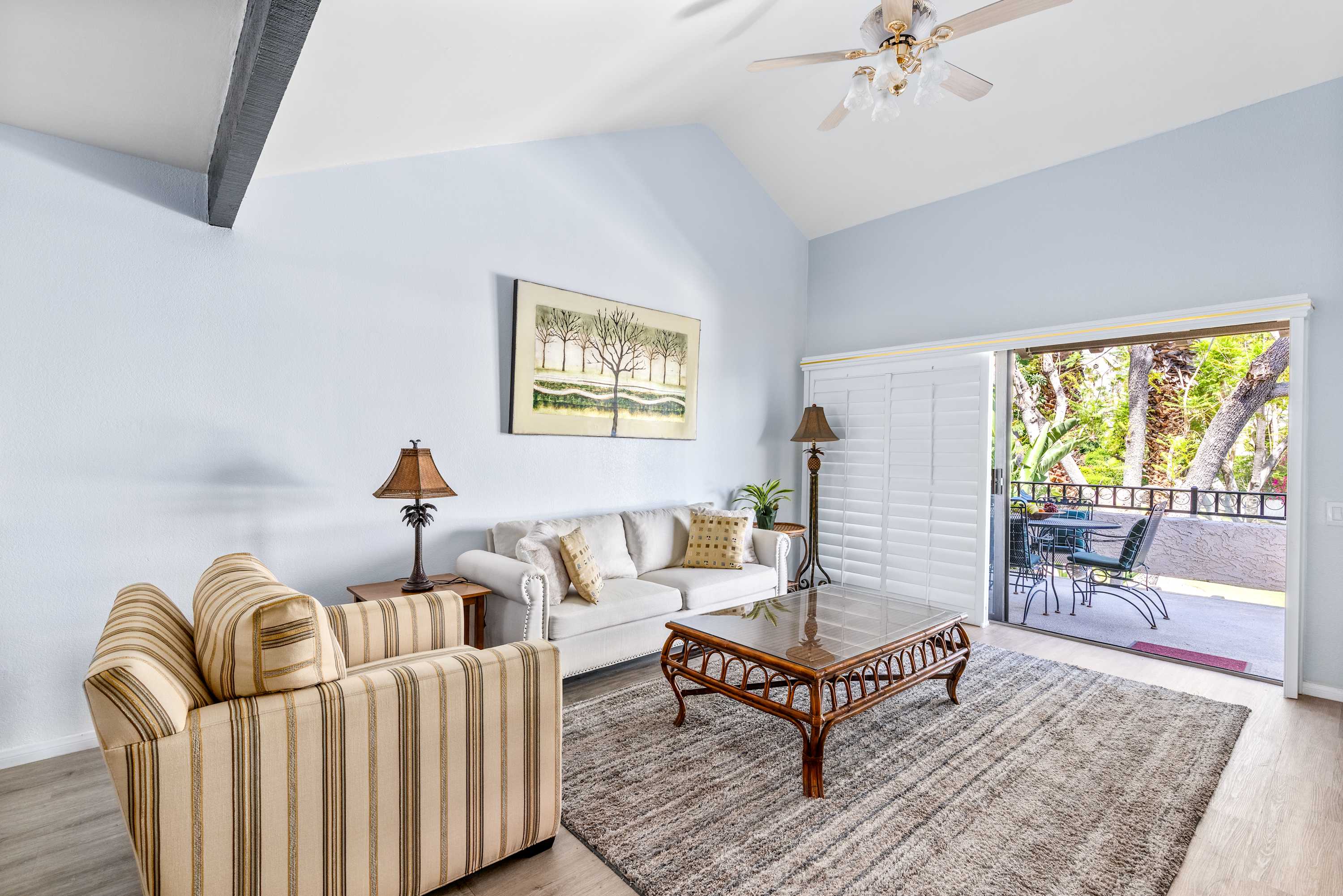 Living-room seating with a sofa, armchairs and a coffee table beside the outdoor door.