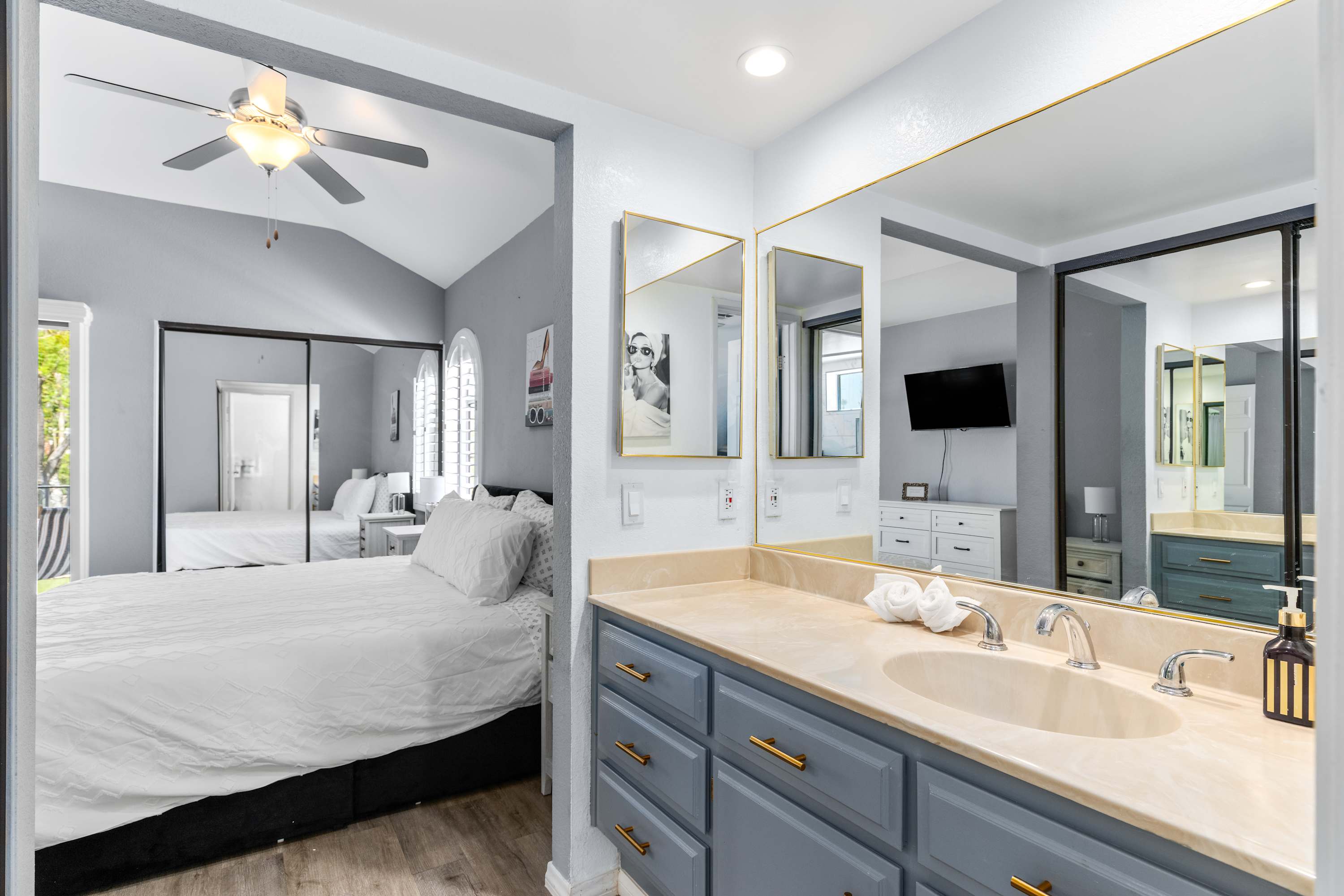 Double vanity and mirror beside the adjoining bedroom.
