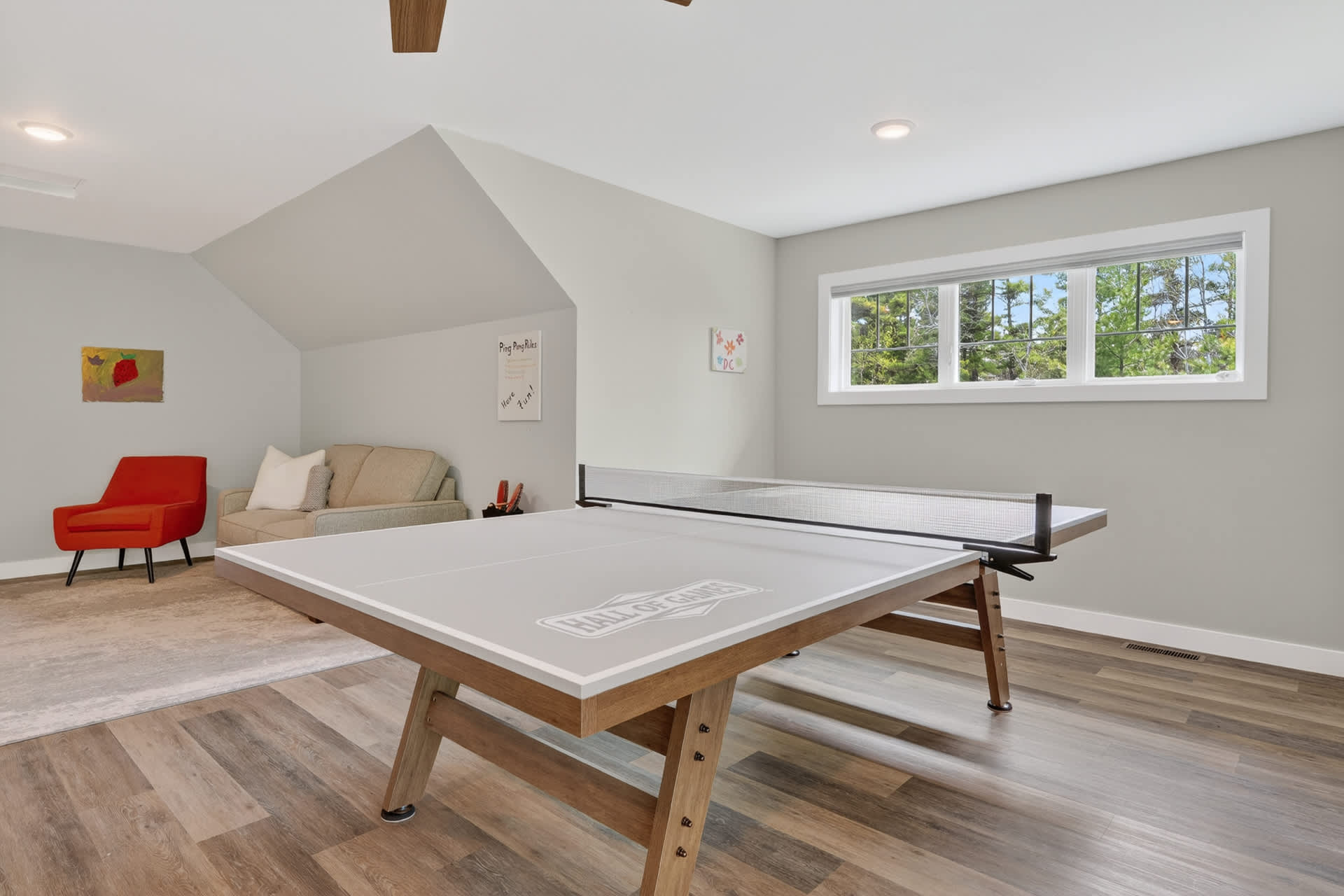 Step into your private game room, where laughter and friendly competition await. Challenge your companions to ping-pong under high vaulted ceilings, surrounded by natural light and modern comfort.