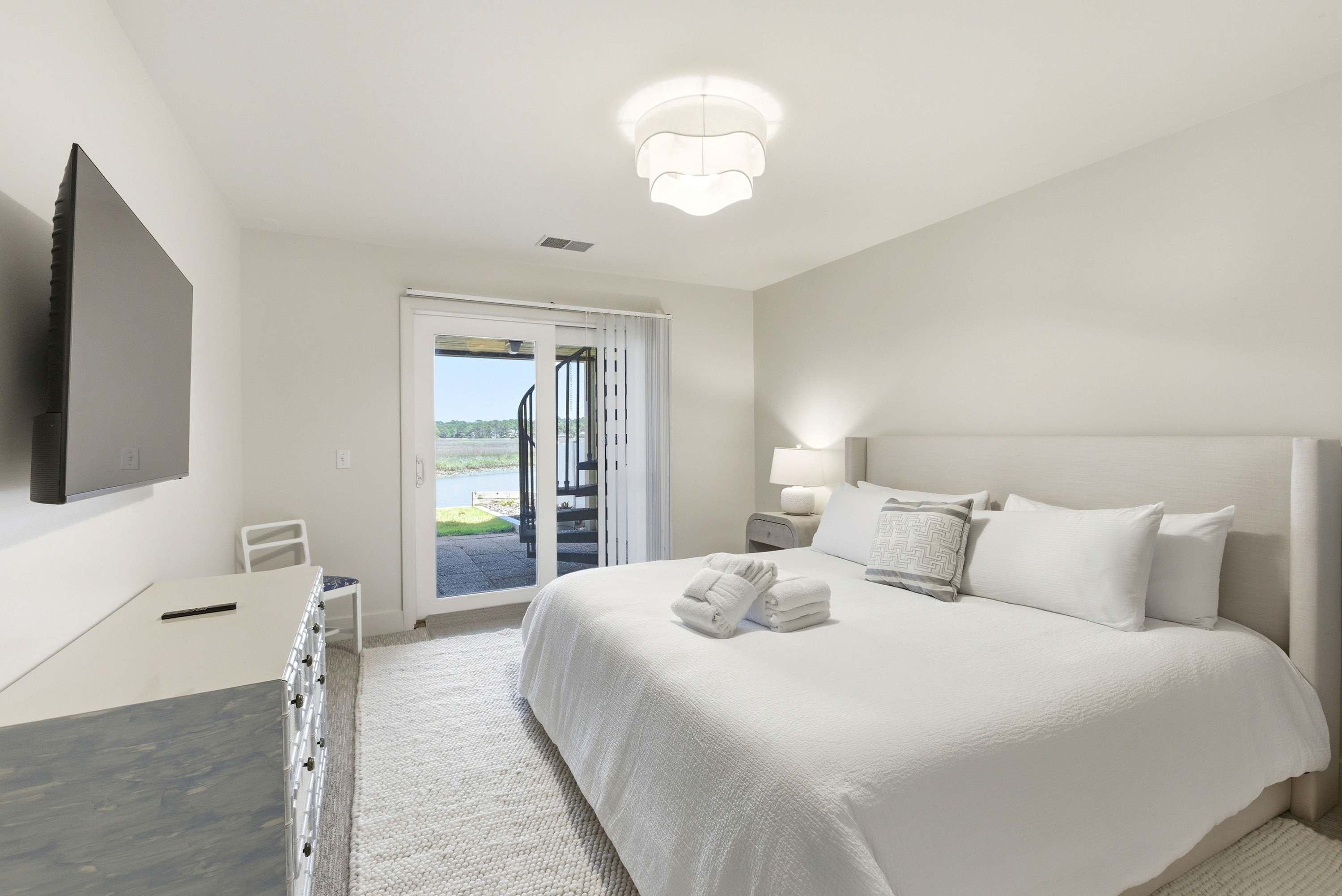 Shimmering water views greet you through the sliding glass doors of this bright king bedroom with direct balcony access.