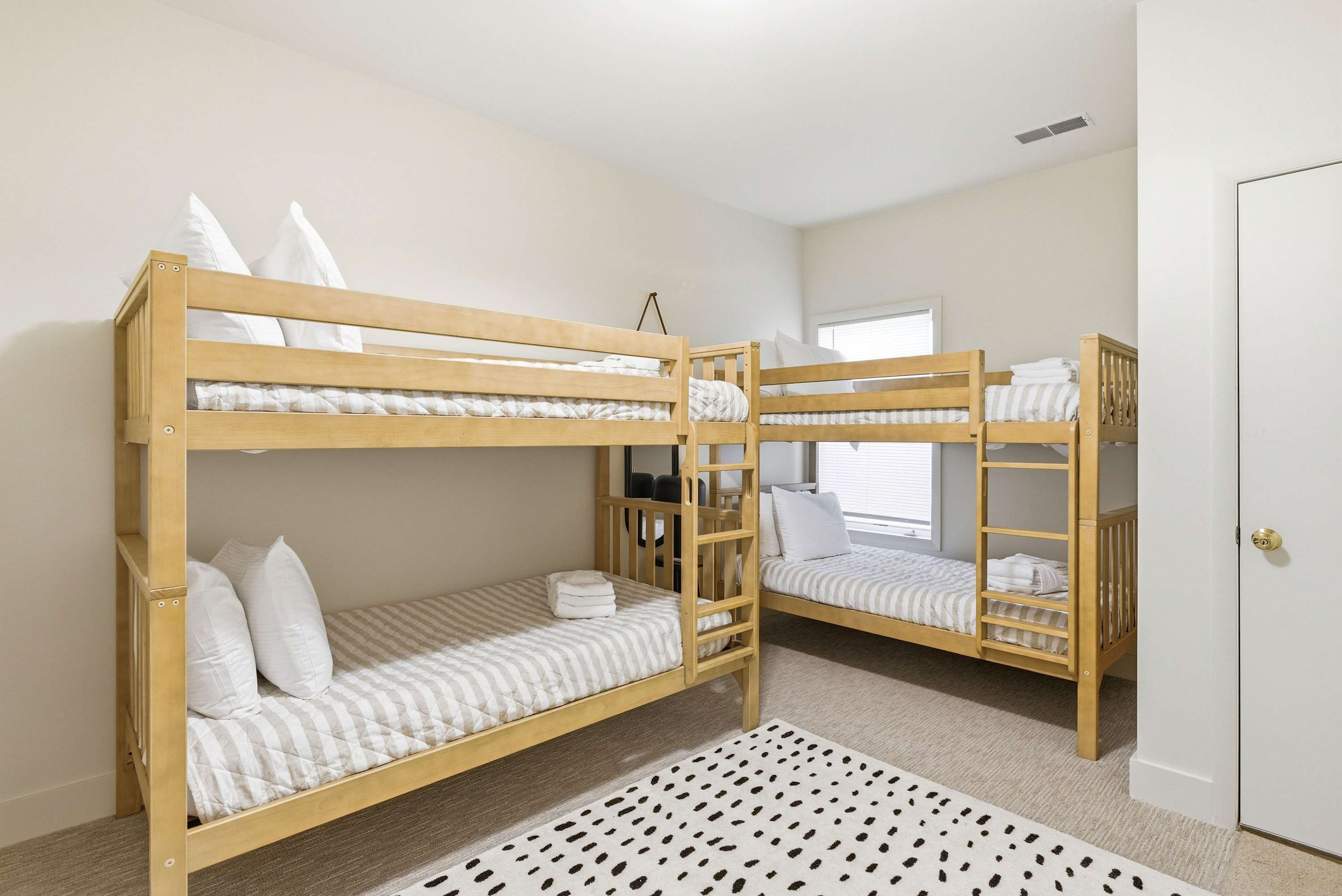 Dual bunk sets sleep four in this playful, well-appointed bunk room — perfect for kids and big groups alike.