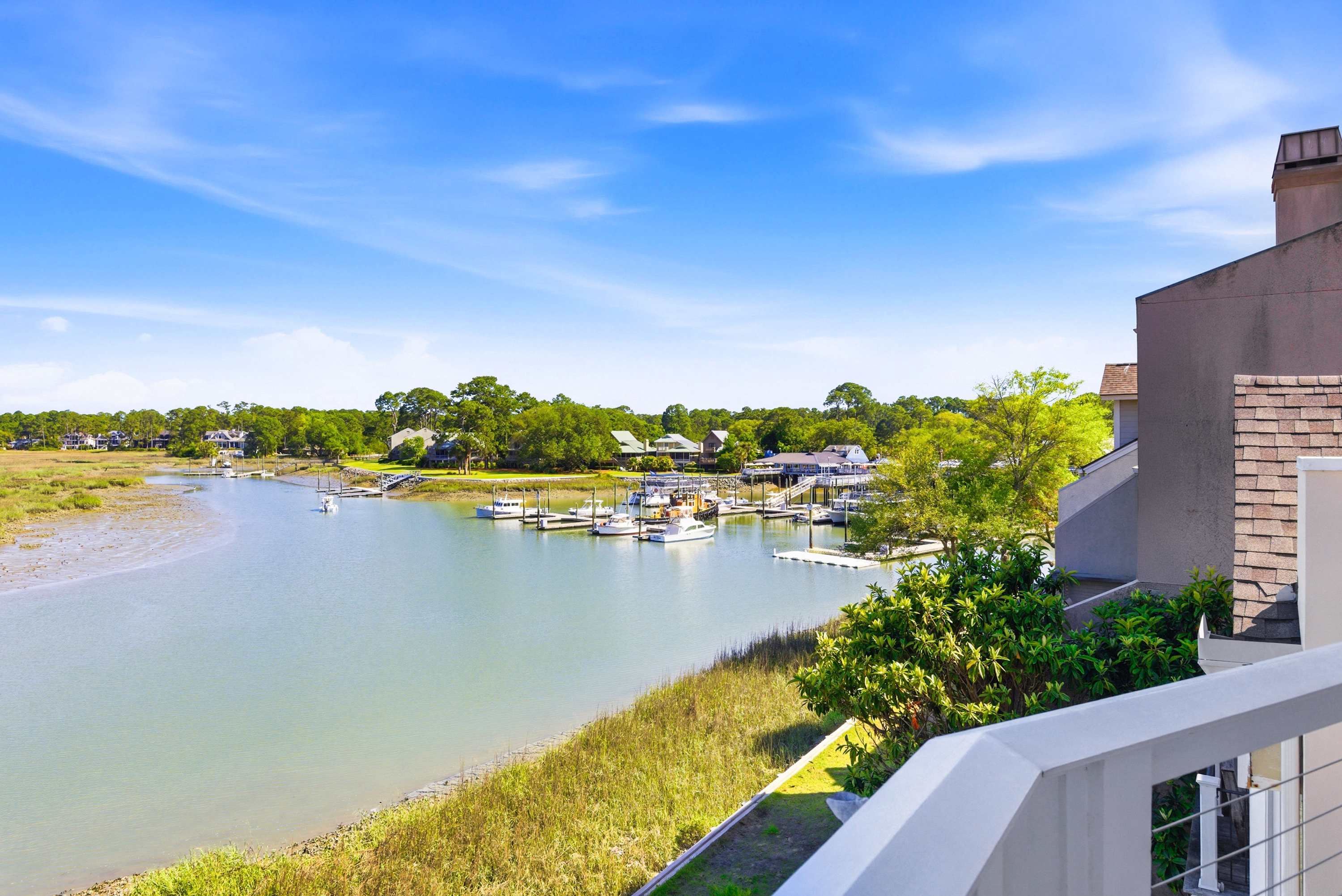 Unobstructed views of the sparkling waterway and neighboring marina from your private upper balcony.
