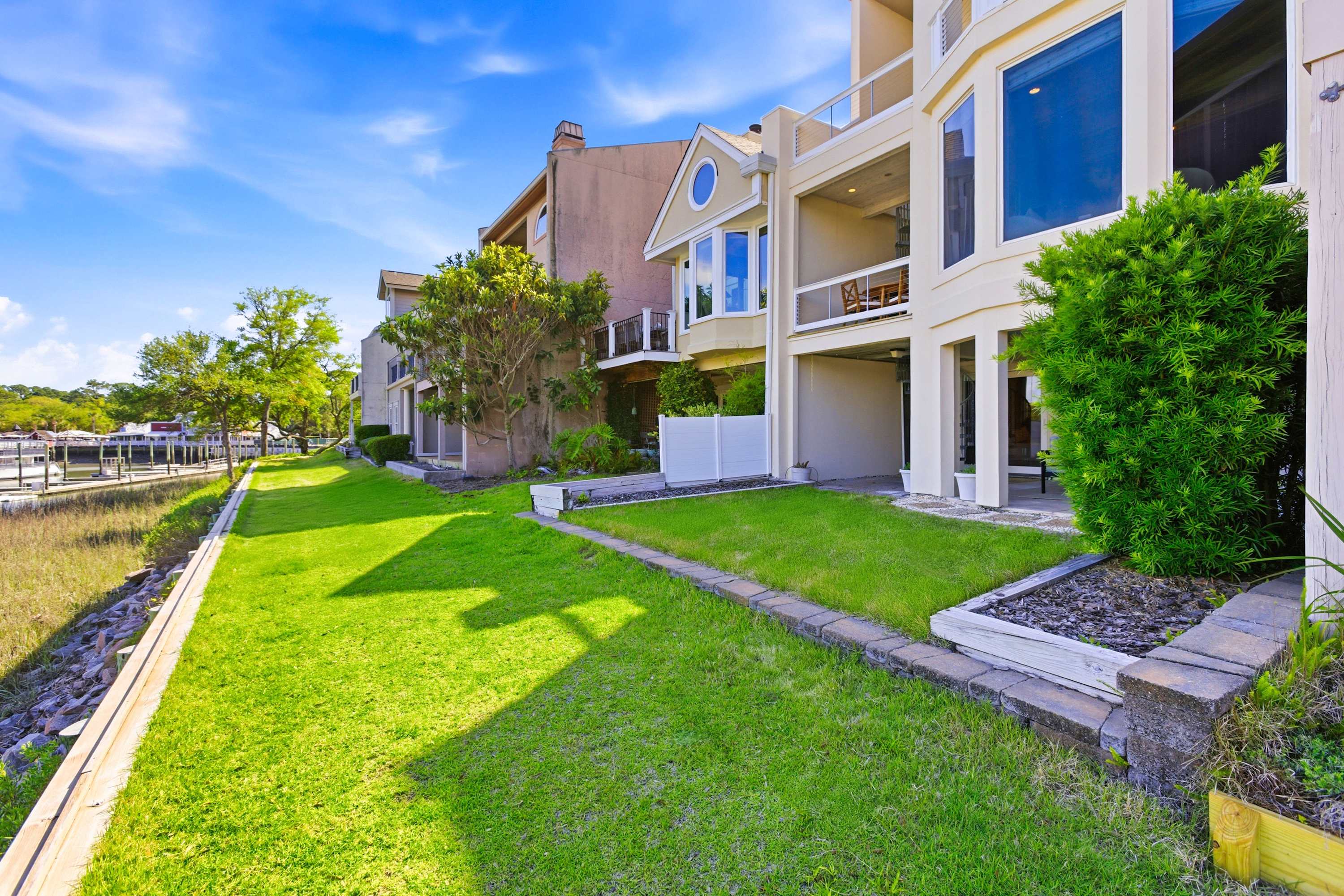 Beautifully landscaped grounds hug the waterway's edge, with docks, natural salt marsh, and coastal scenery at every turn.