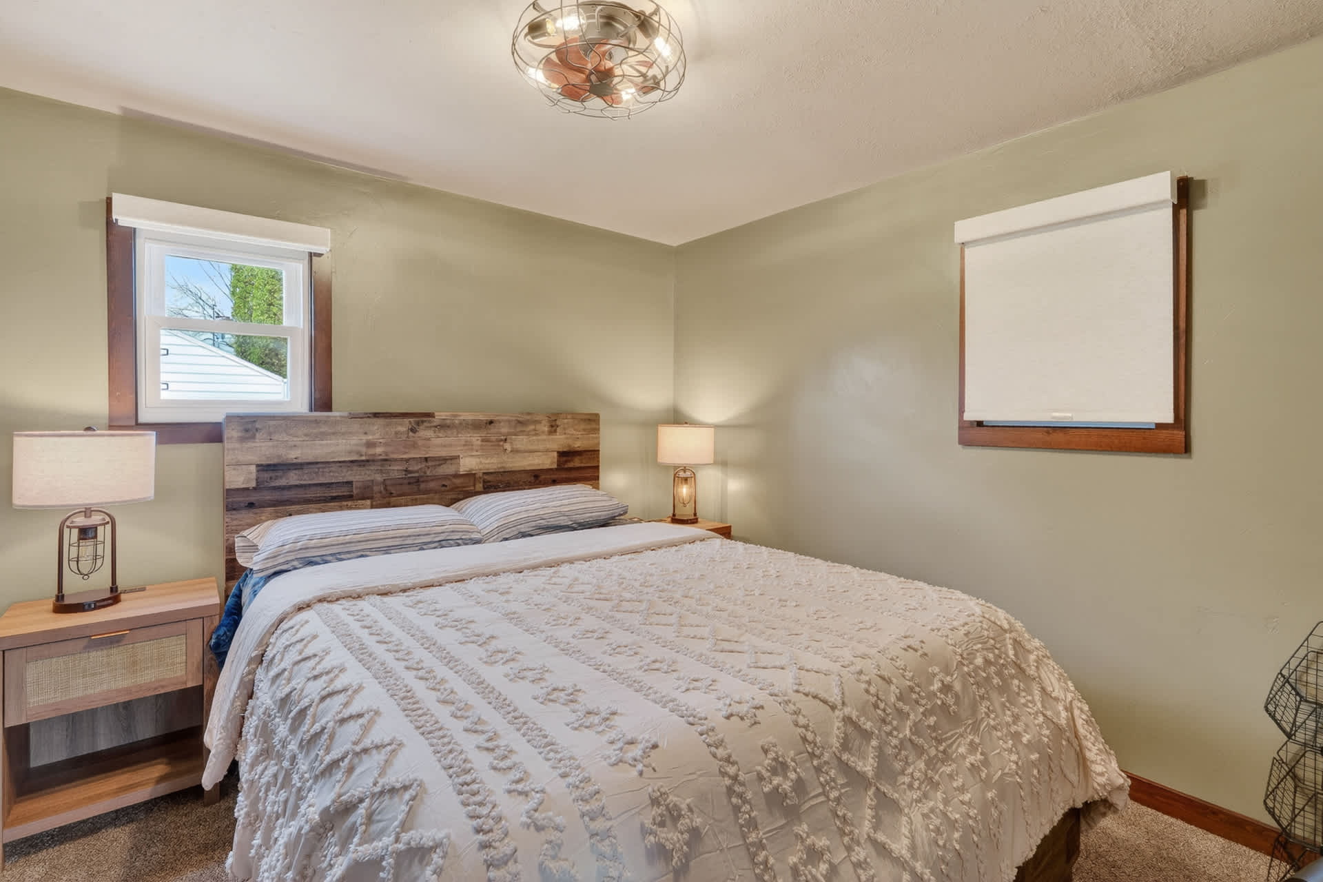 Bedroom 1- Queen bed. Relax in your peaceful bedroom with soft linens, rustic wood tones, and warm lighting that make unwinding effortless after a day of exploring.