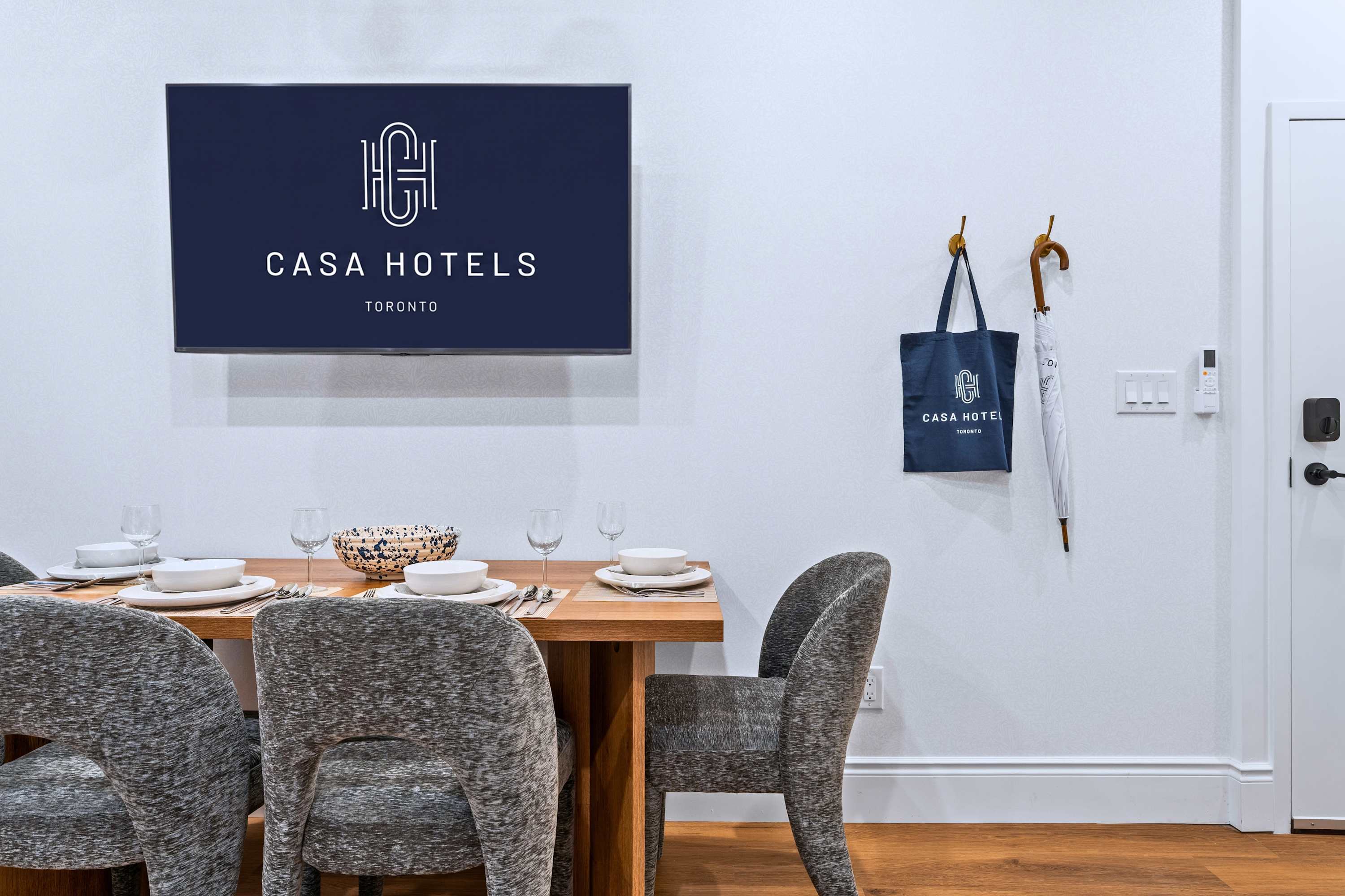 Dining area with Smart TV and thoughtful guest touches like umbrella and tote bag for added convenience