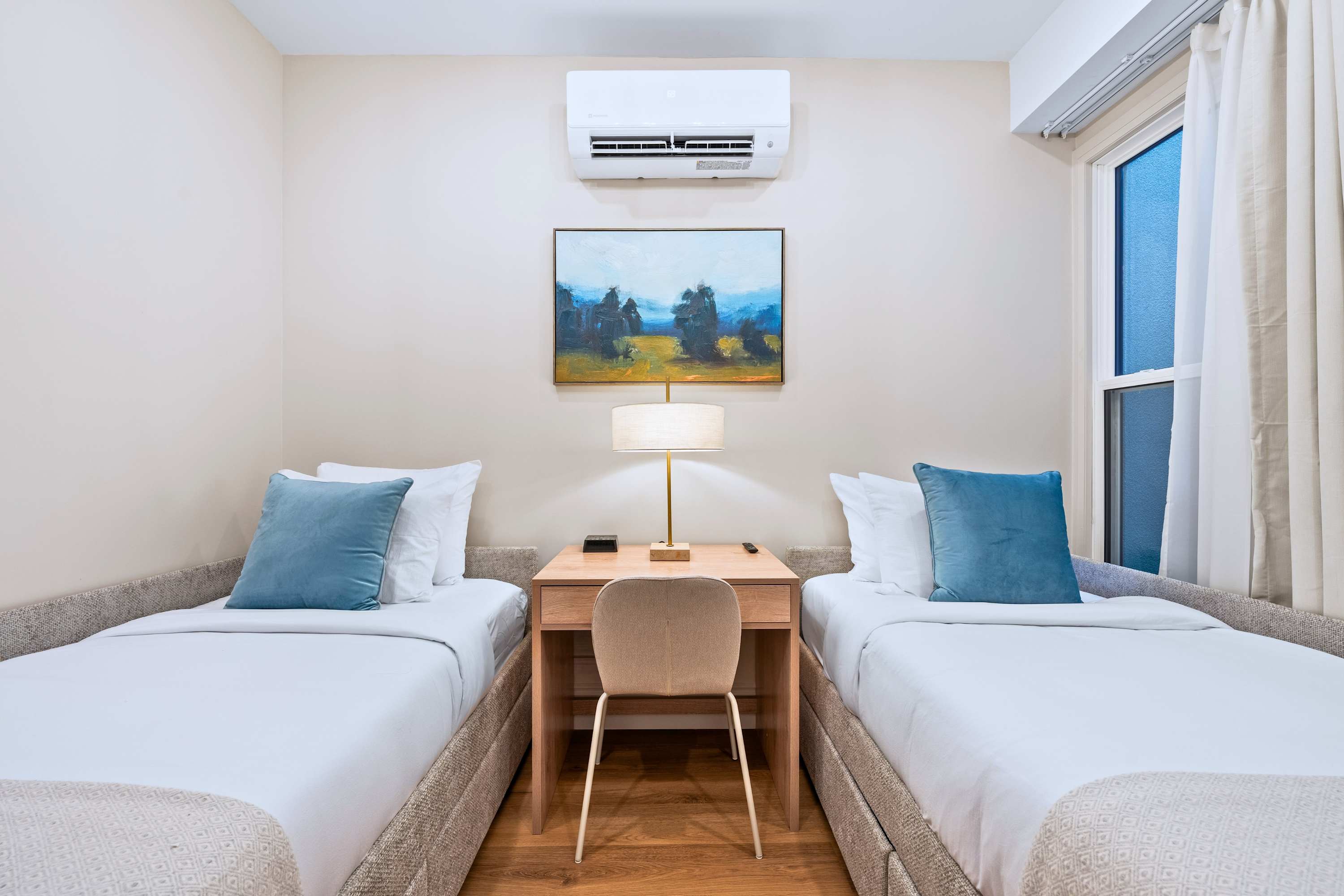Bedroom with two single beds, quality robes, and soft bedding for a comfortable stay