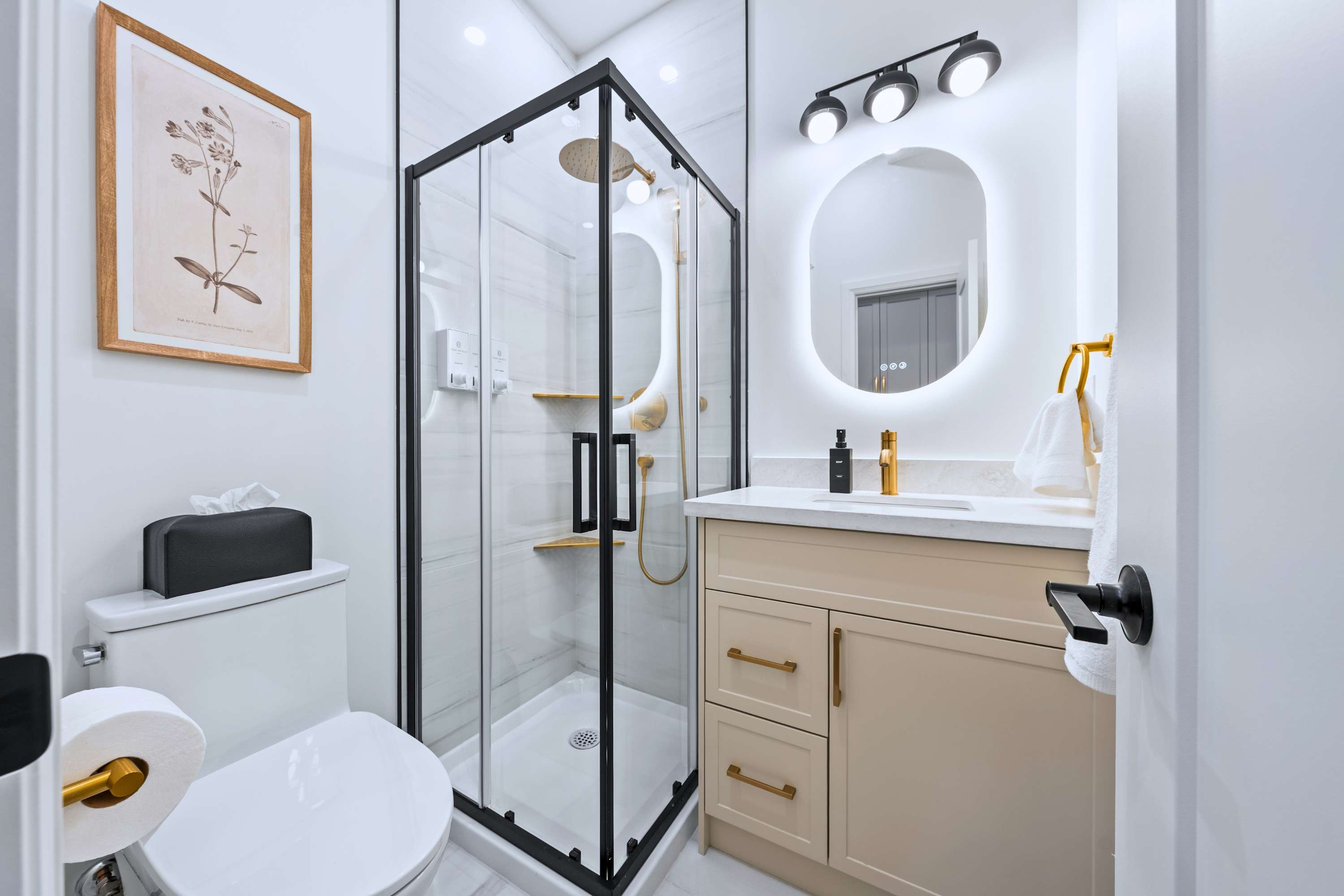 Modern, well-lit bathroom with a walk-in shower.