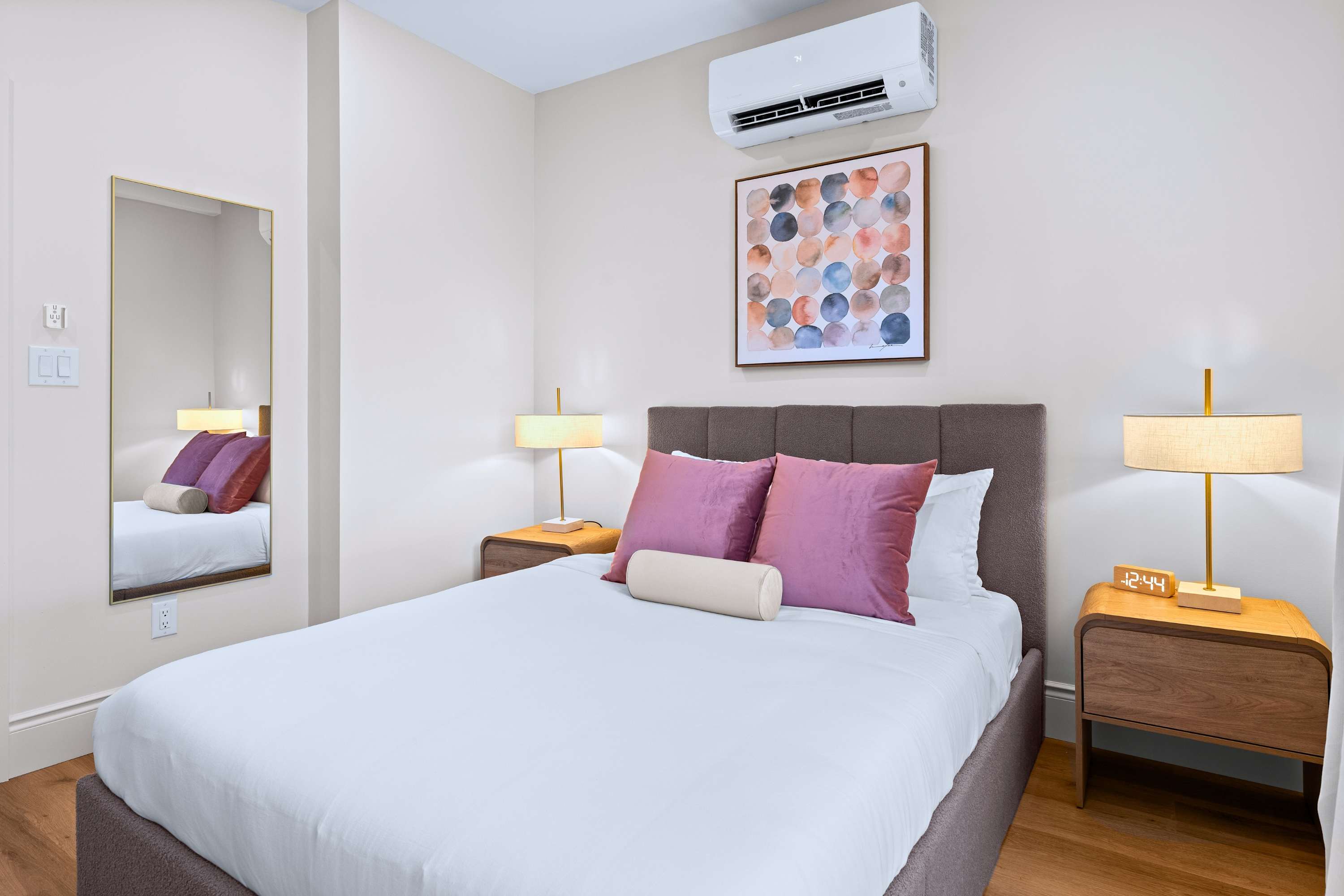 Peaceful air-conditioned bedroom featuring fresh linens and soft pillows.