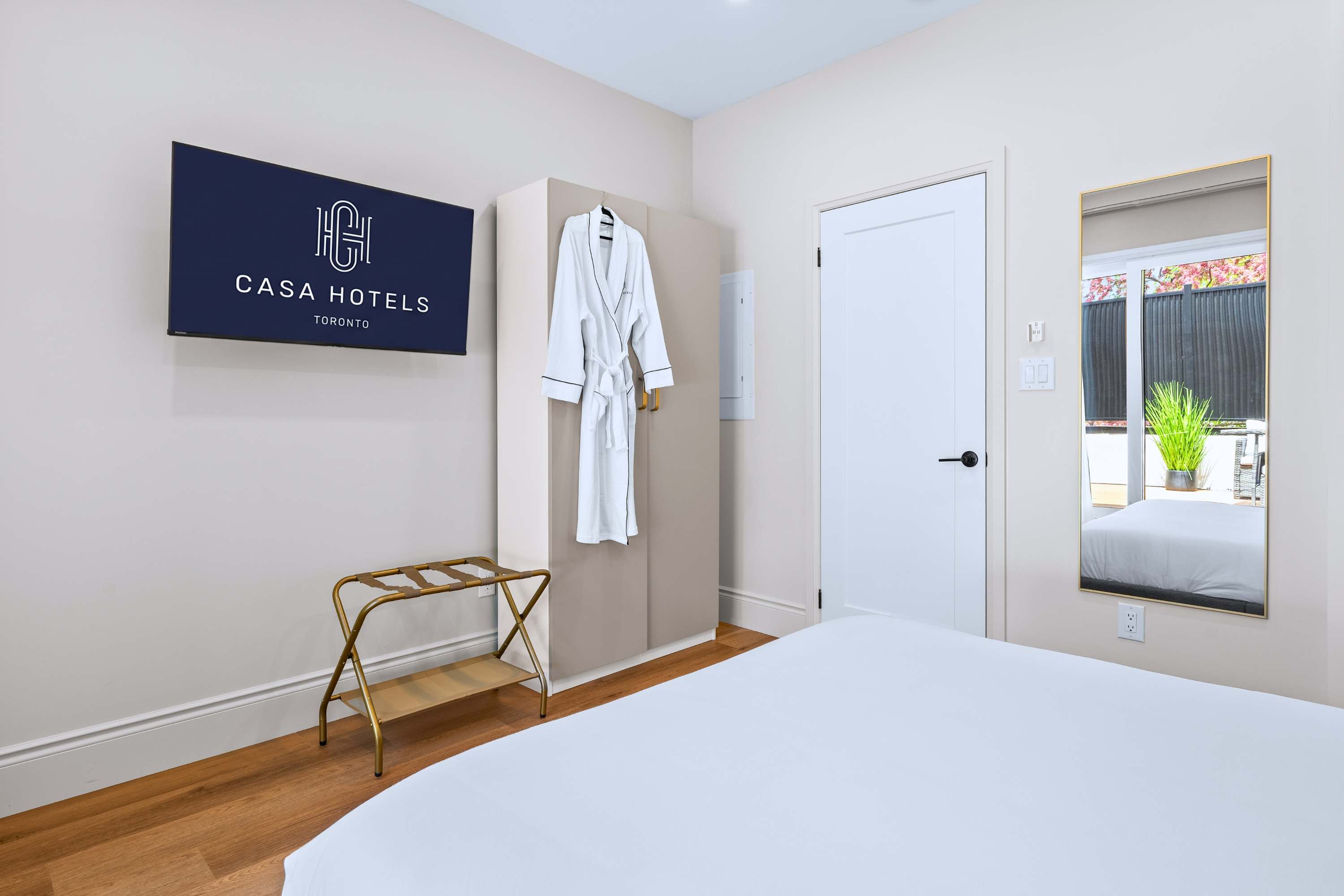 Simple, inviting space with soft bedding and bathrobe comfort.