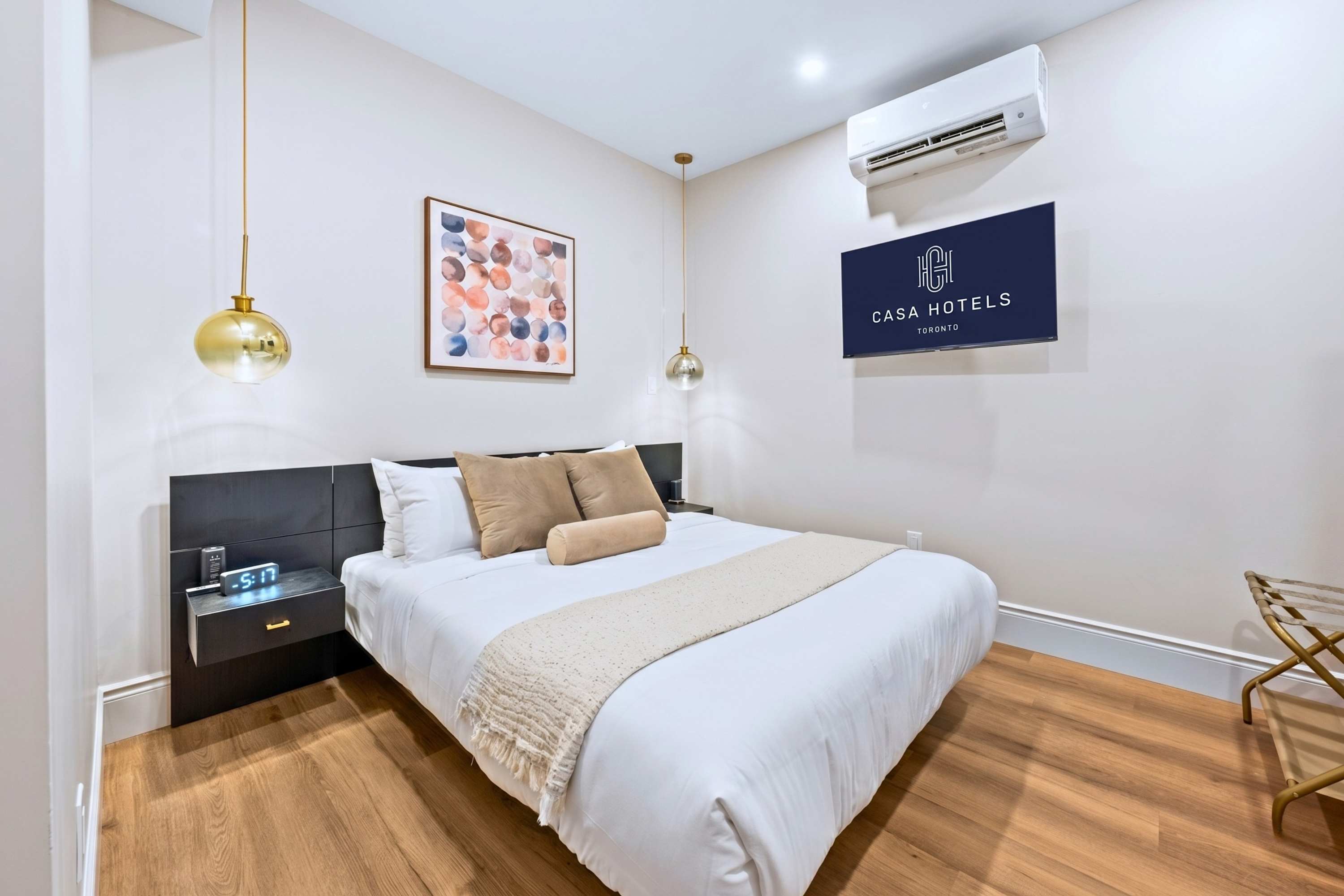 Restful queen space with soft layers, cool air, and entertainment for slow nights in