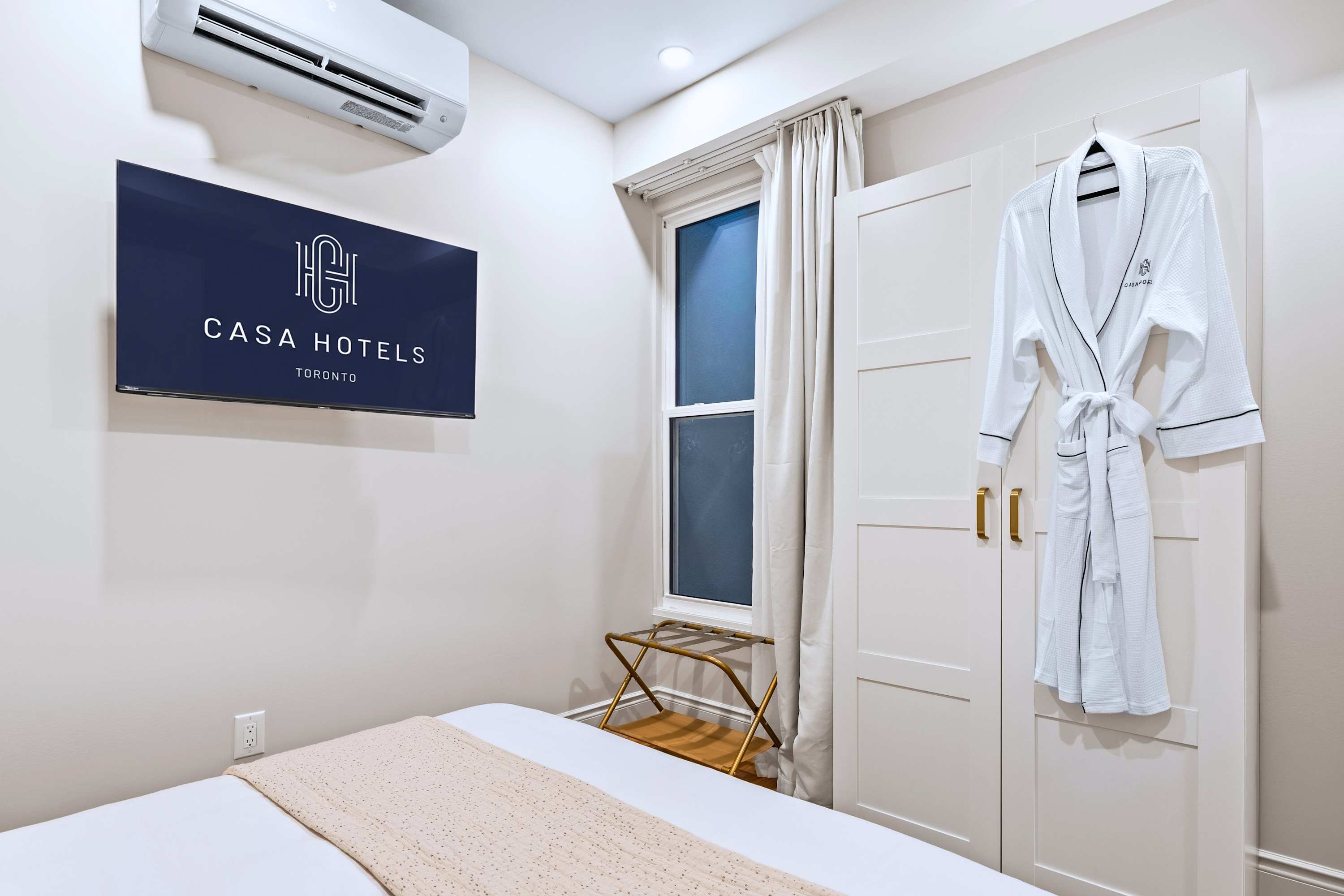 Queen retreat with comfy bedding, cool air, and a private screen for slow, easy nights in