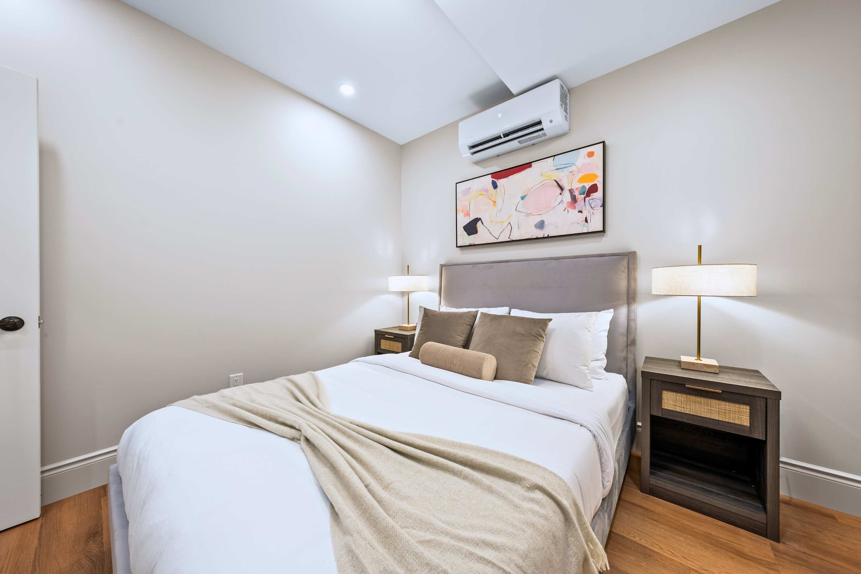 Queen bed with premium bedding designed for deep rest and quiet, uninterrupted nights