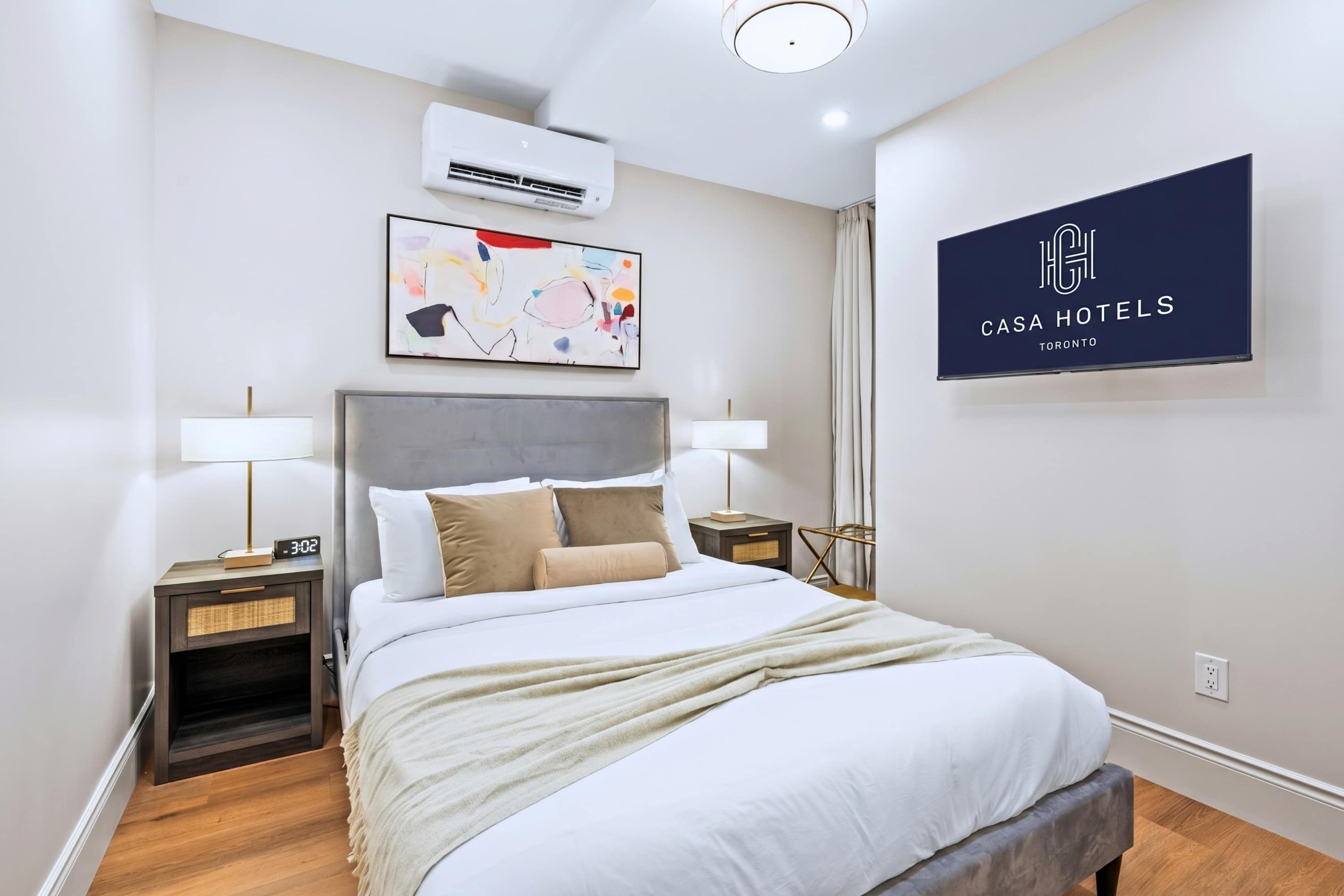 Queen bed with premium bedding and a private screen for relaxed, restful nights in