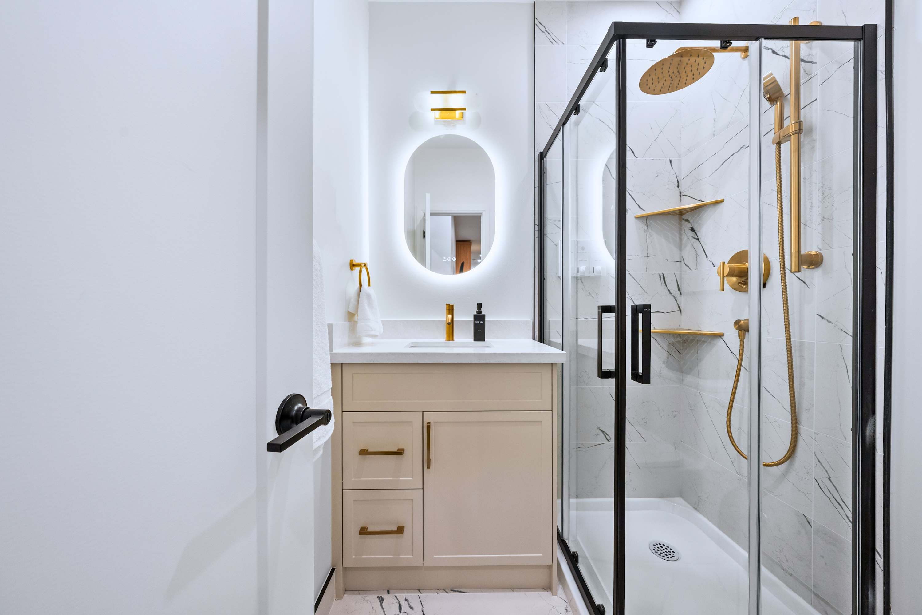 Modern bathroom with walk in shower and illuminated mirror, designed for an easy start and smooth finish to the day
