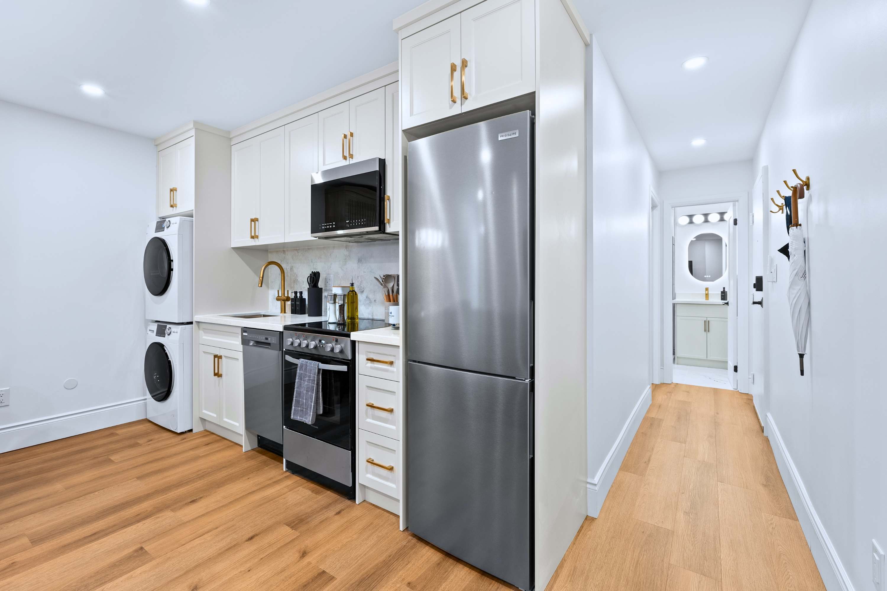 Kitchen area with in suite laundry and nearby bathroom access for added convenience
