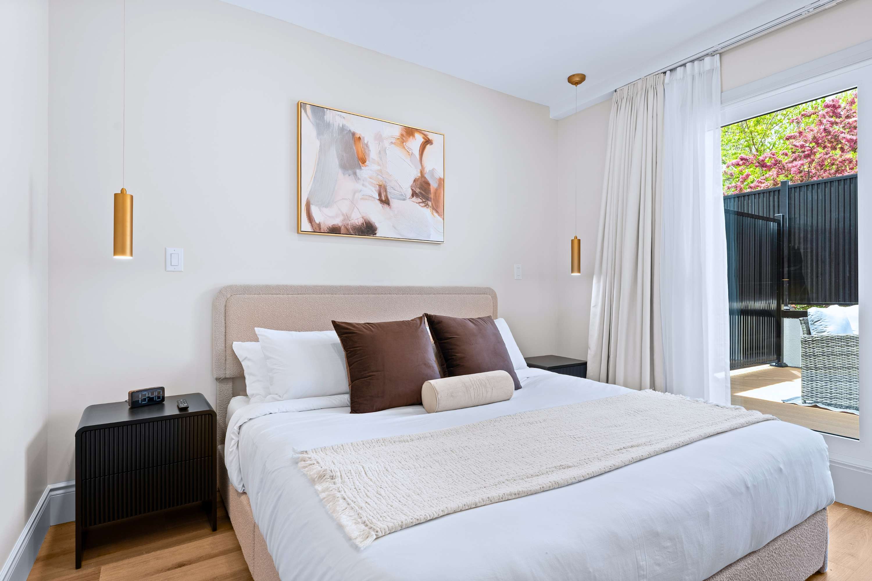 Queen bedroom with quality bedding and a private patio to enjoy fresh air and quiet moments