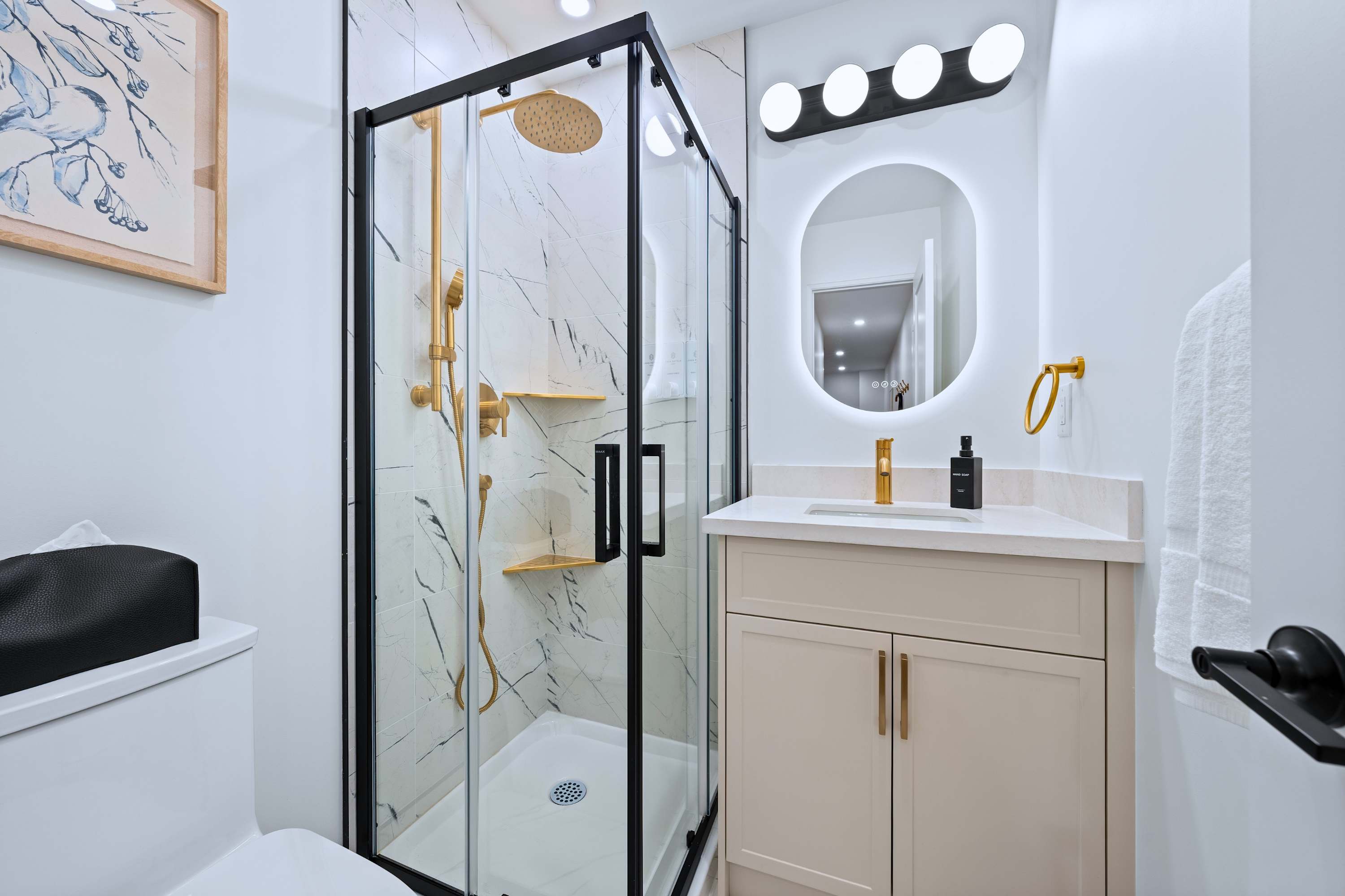 Bathroom with a walk-in shower and a bright mirror set up for effortless getting ready and refreshing