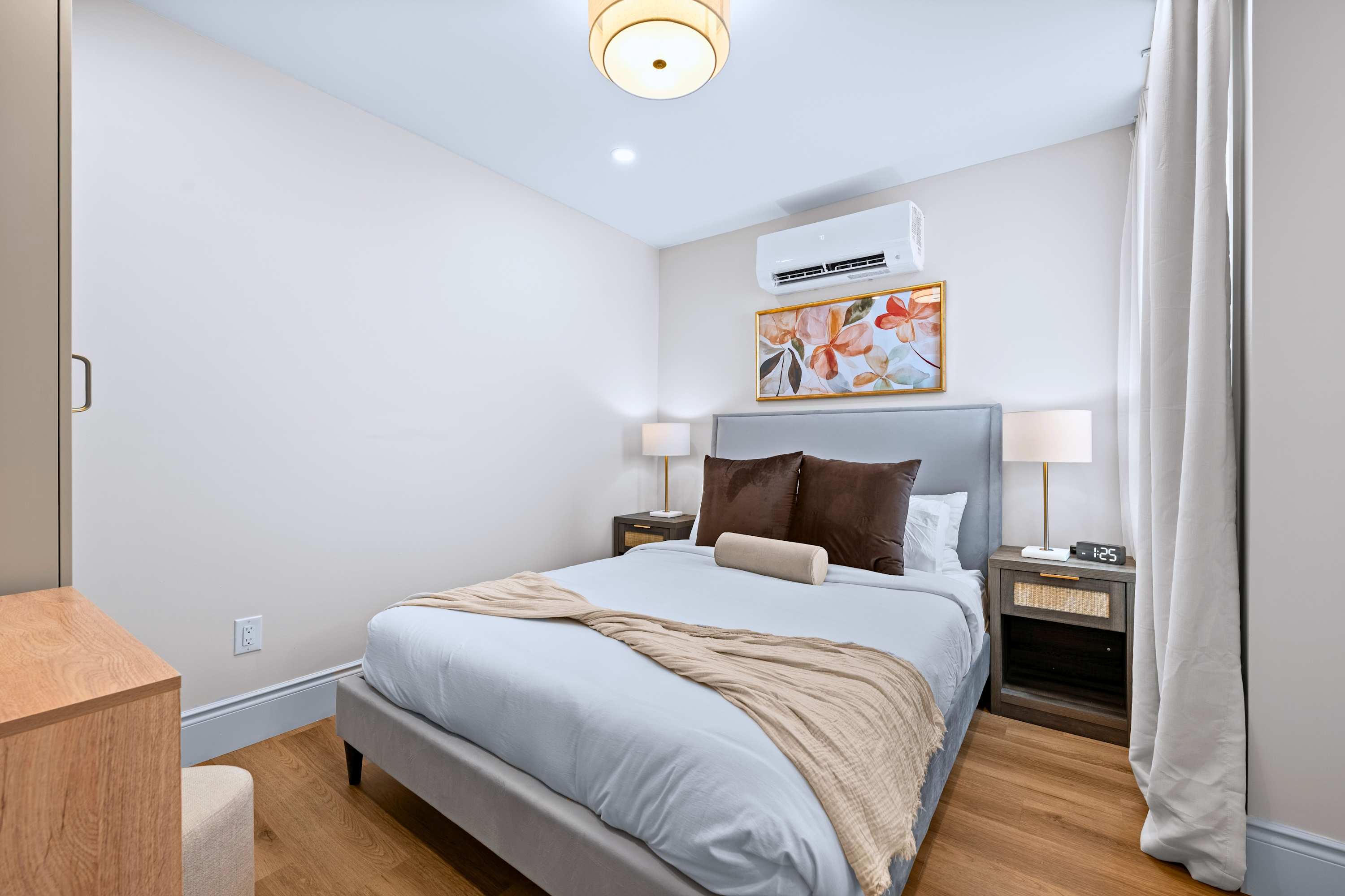 Queen bedroom with quality bedding and air conditioning for a cool, restful sleep