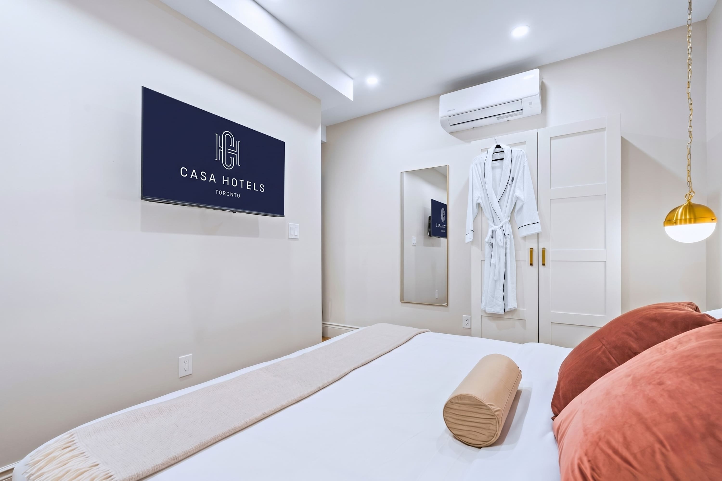 Relax in this king-sized bedroom with a warm and inviting feel.