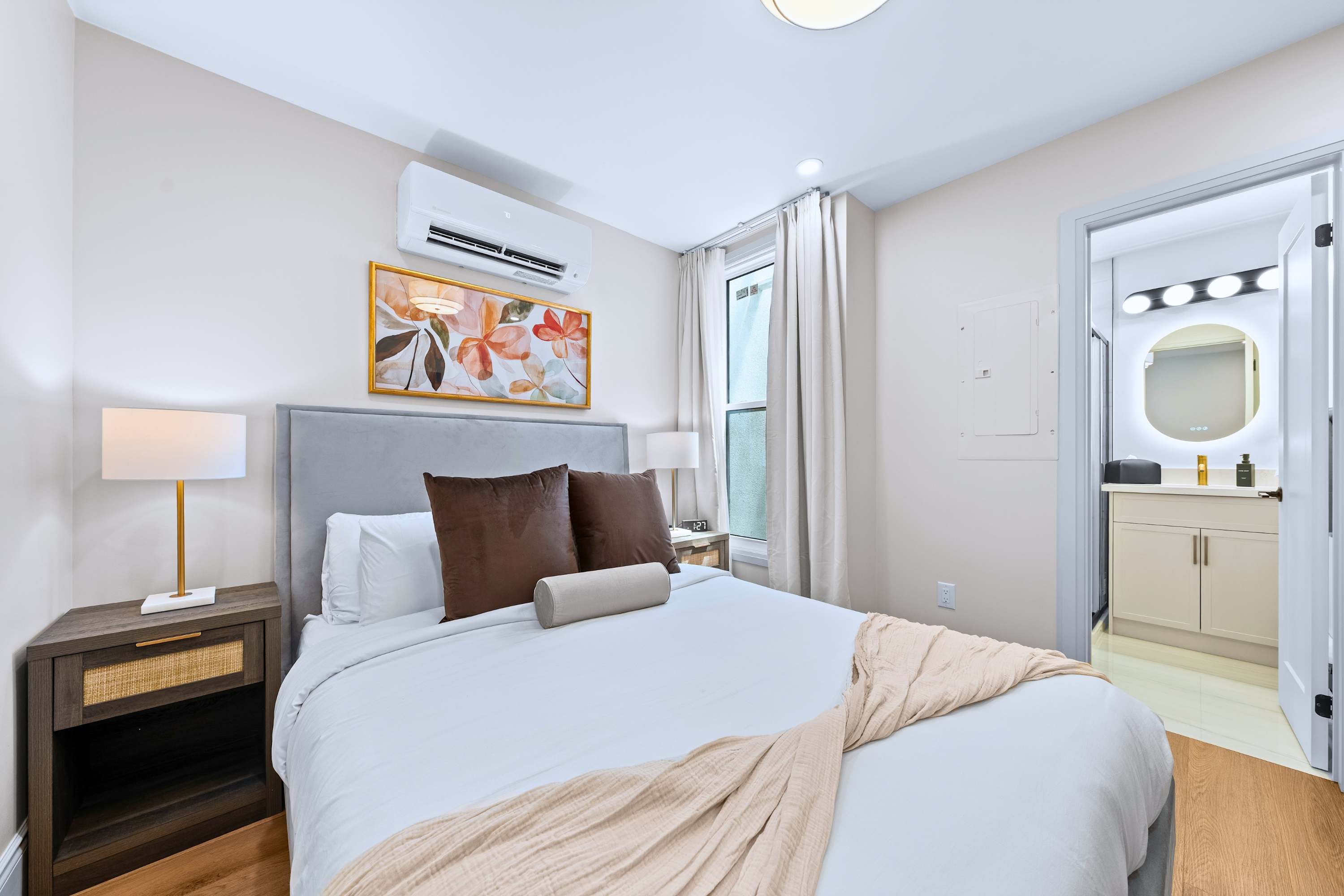 Queen bedroom with quality bedding and direct bathroom access for a smooth, comfortable stay