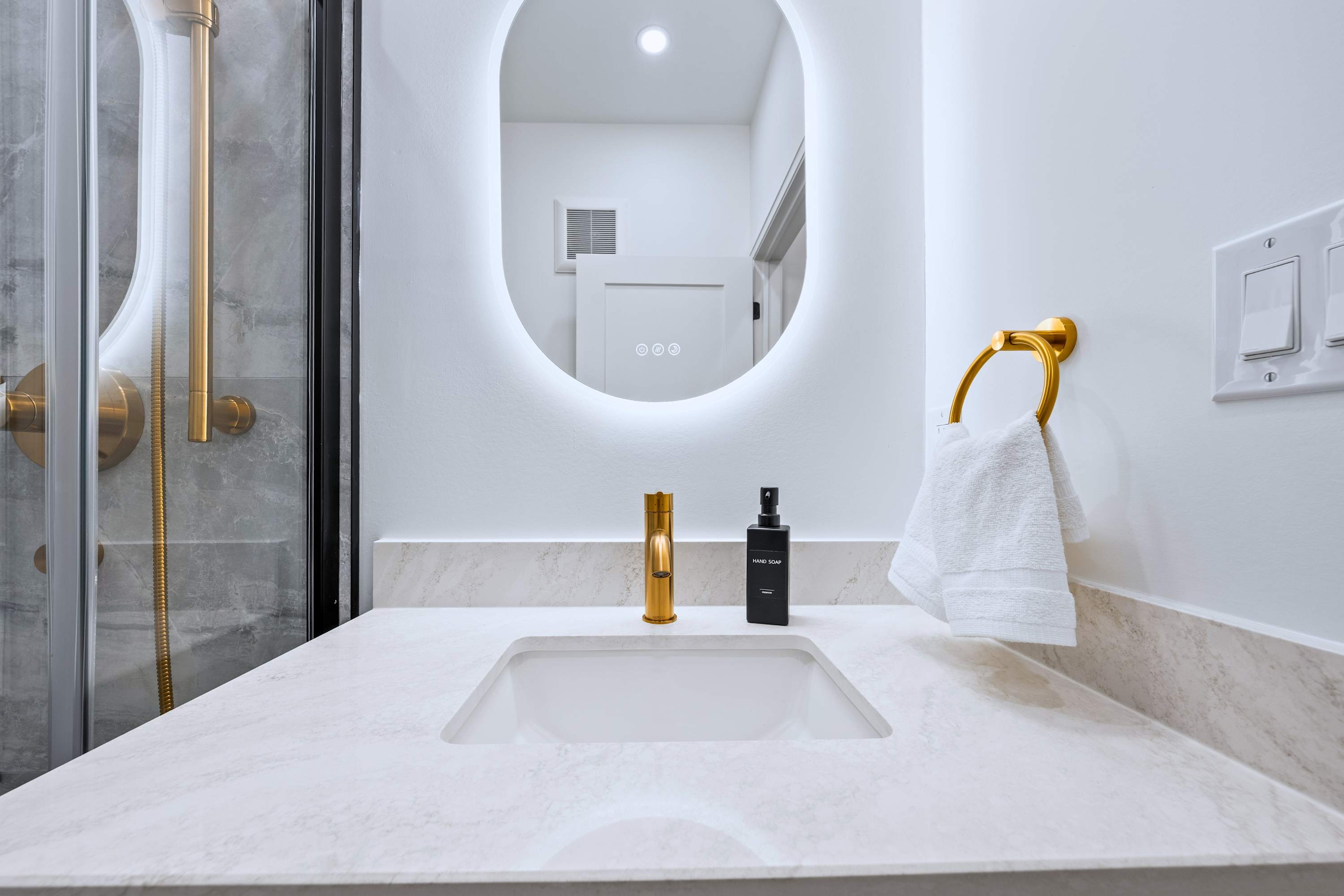 Bathroom sink paired with a bright mirror, perfect for getting ready.