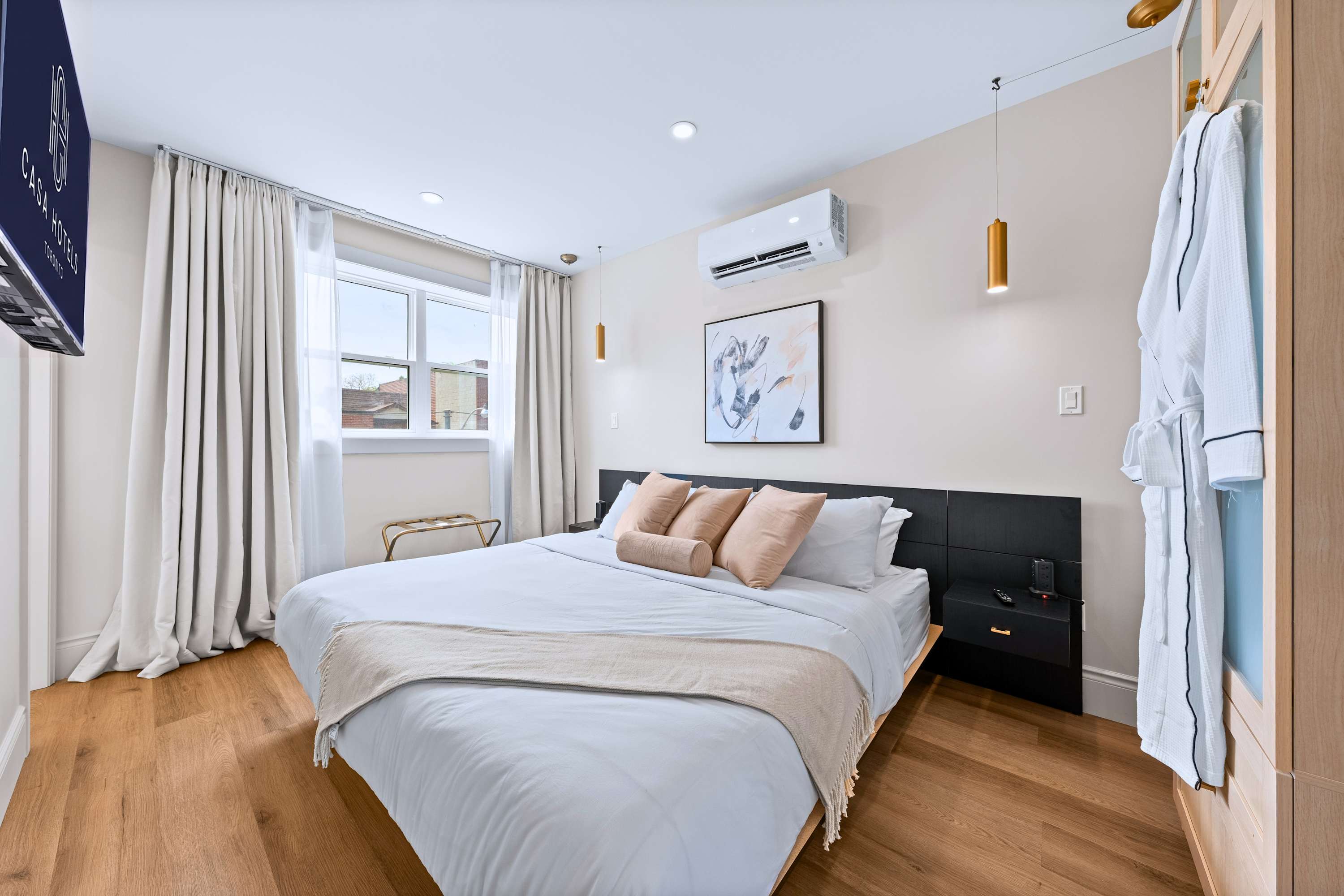Peaceful space featuring clean bedding and a soft bathrobe.