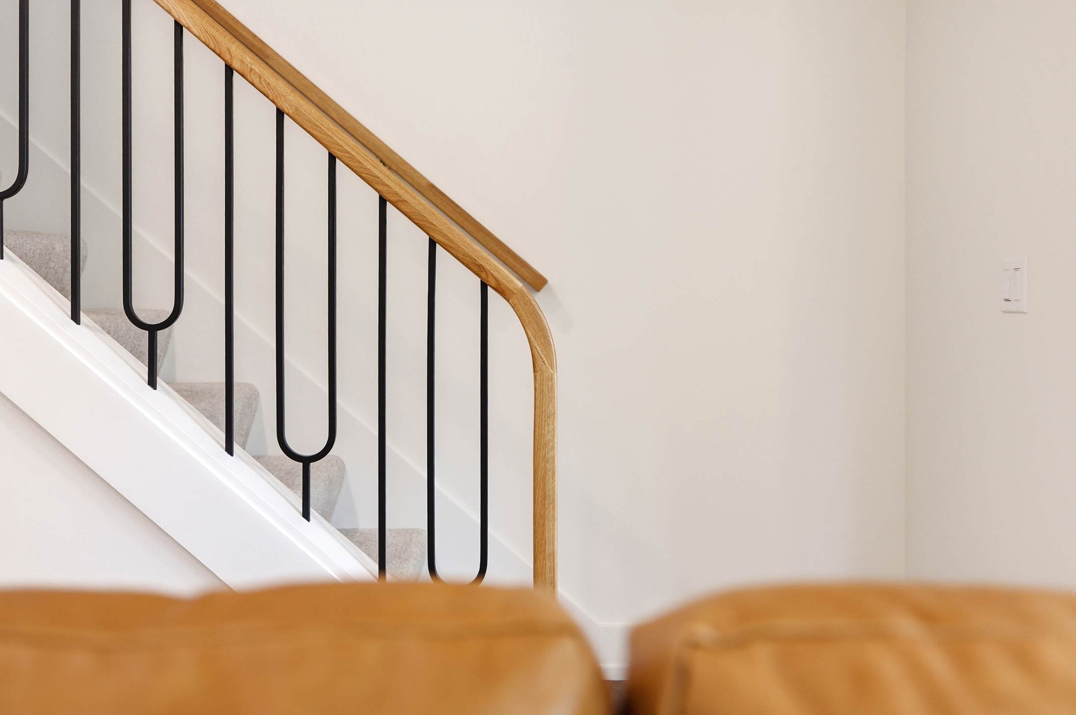 Custom ironwork and warm oak, designed to be noticed.