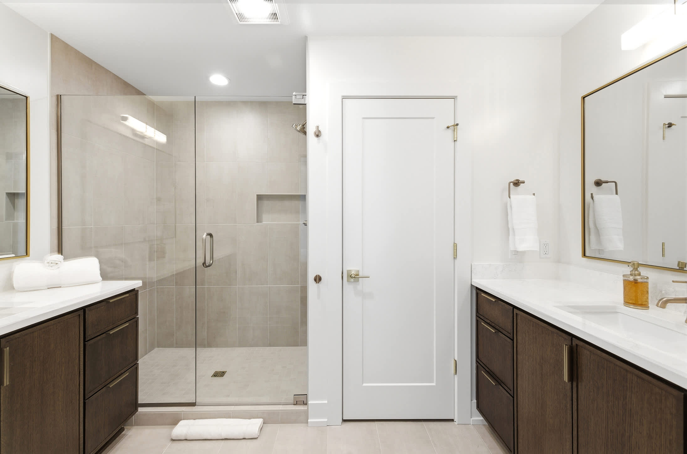 Dual vanities and a walk-in shower make the primary suite feel like a hotel.