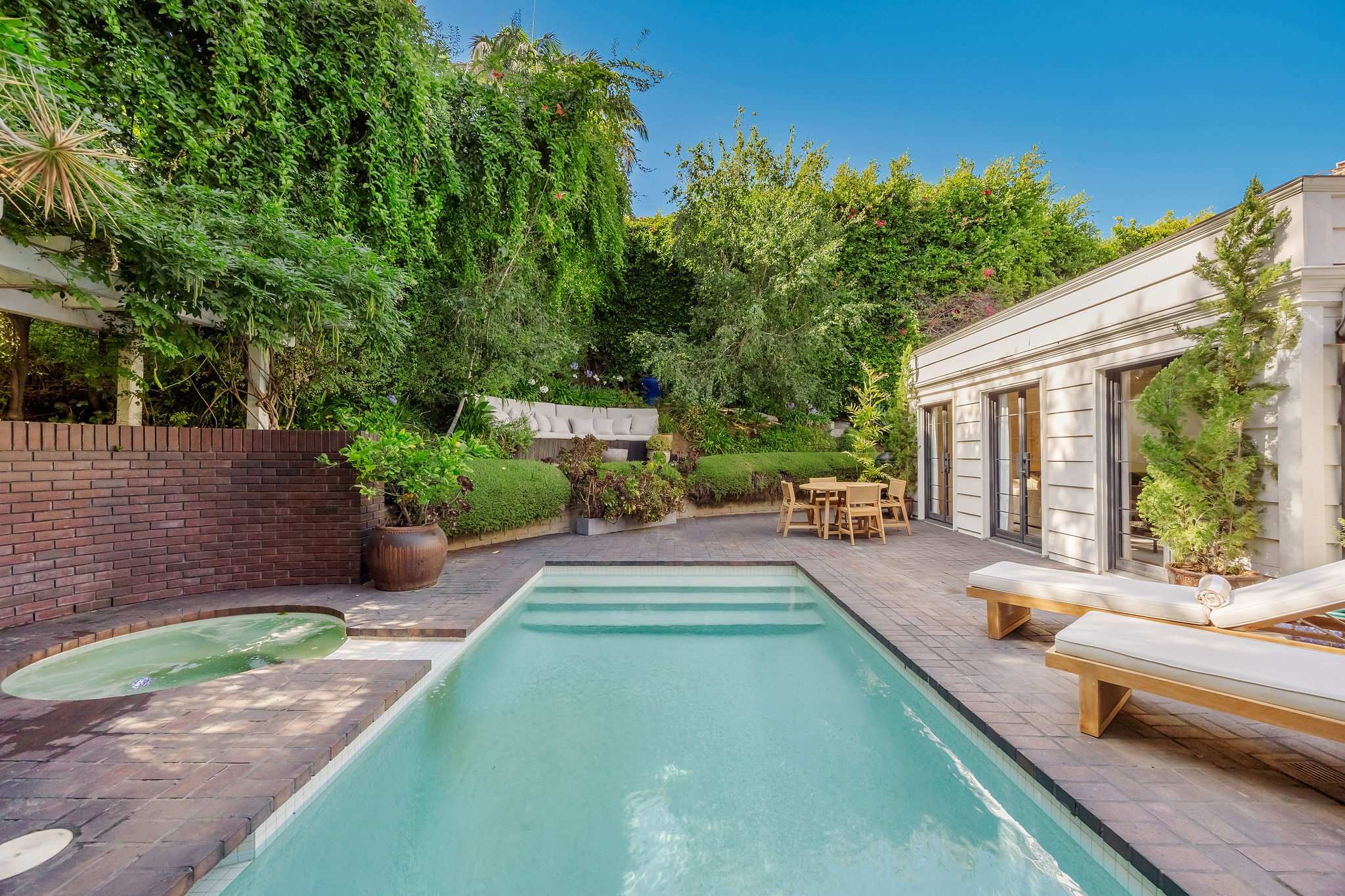 Spend sunny afternoons lounging beside a secluded courtyard pool.