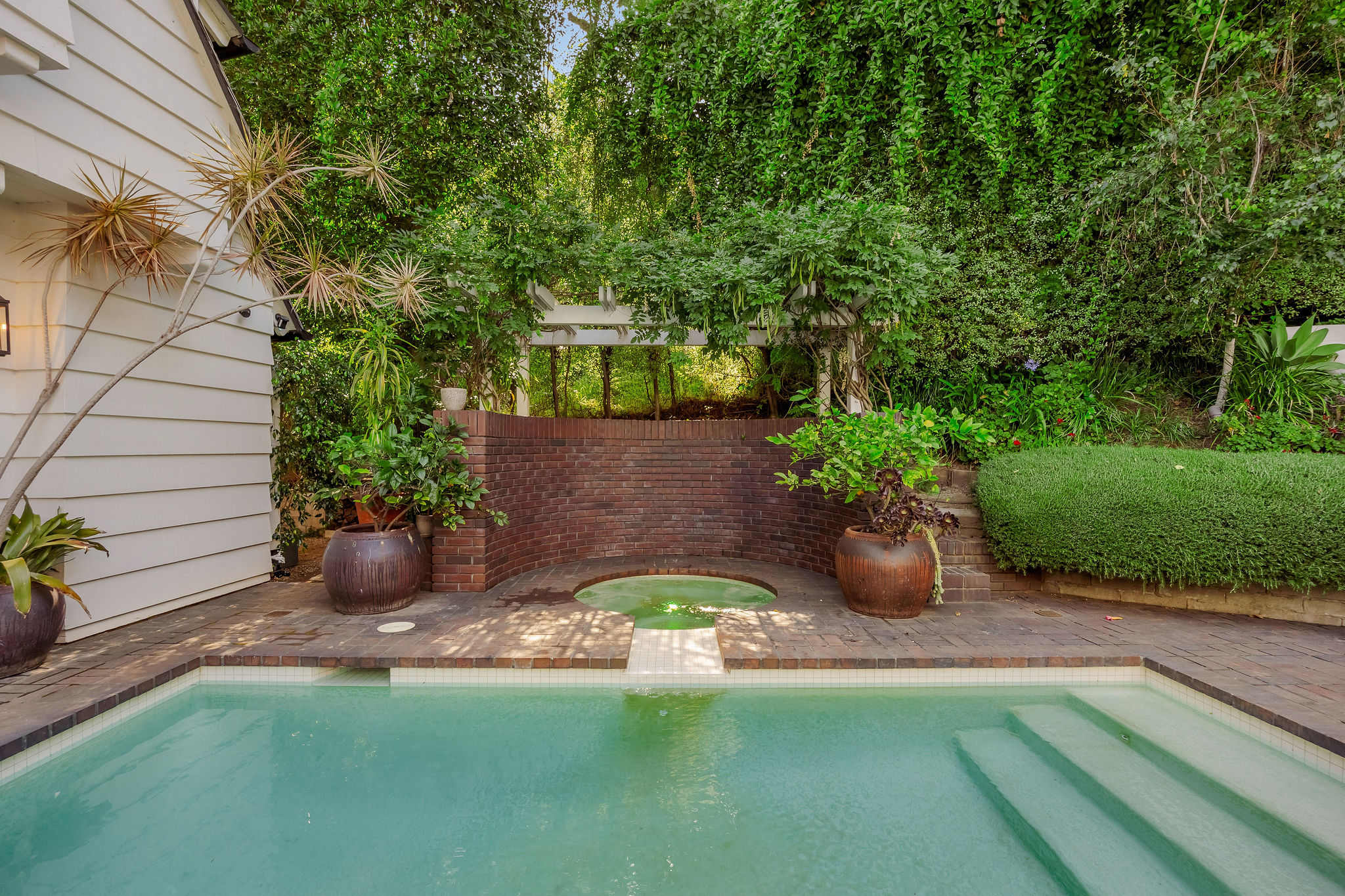 Cool off in your private oasis surrounded by lush greenery.
