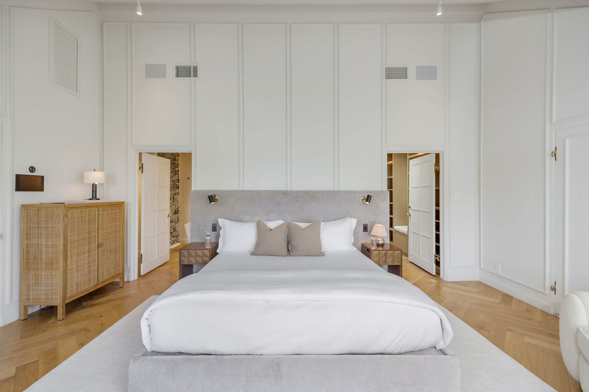 Wake up in a serene primary suite with soaring ceilings and designer finishes