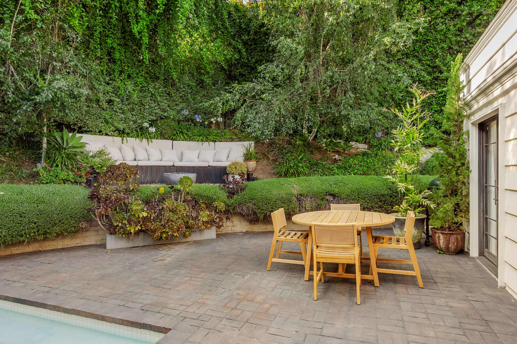 Gather for al fresco dining beneath mature trees and blue skies.