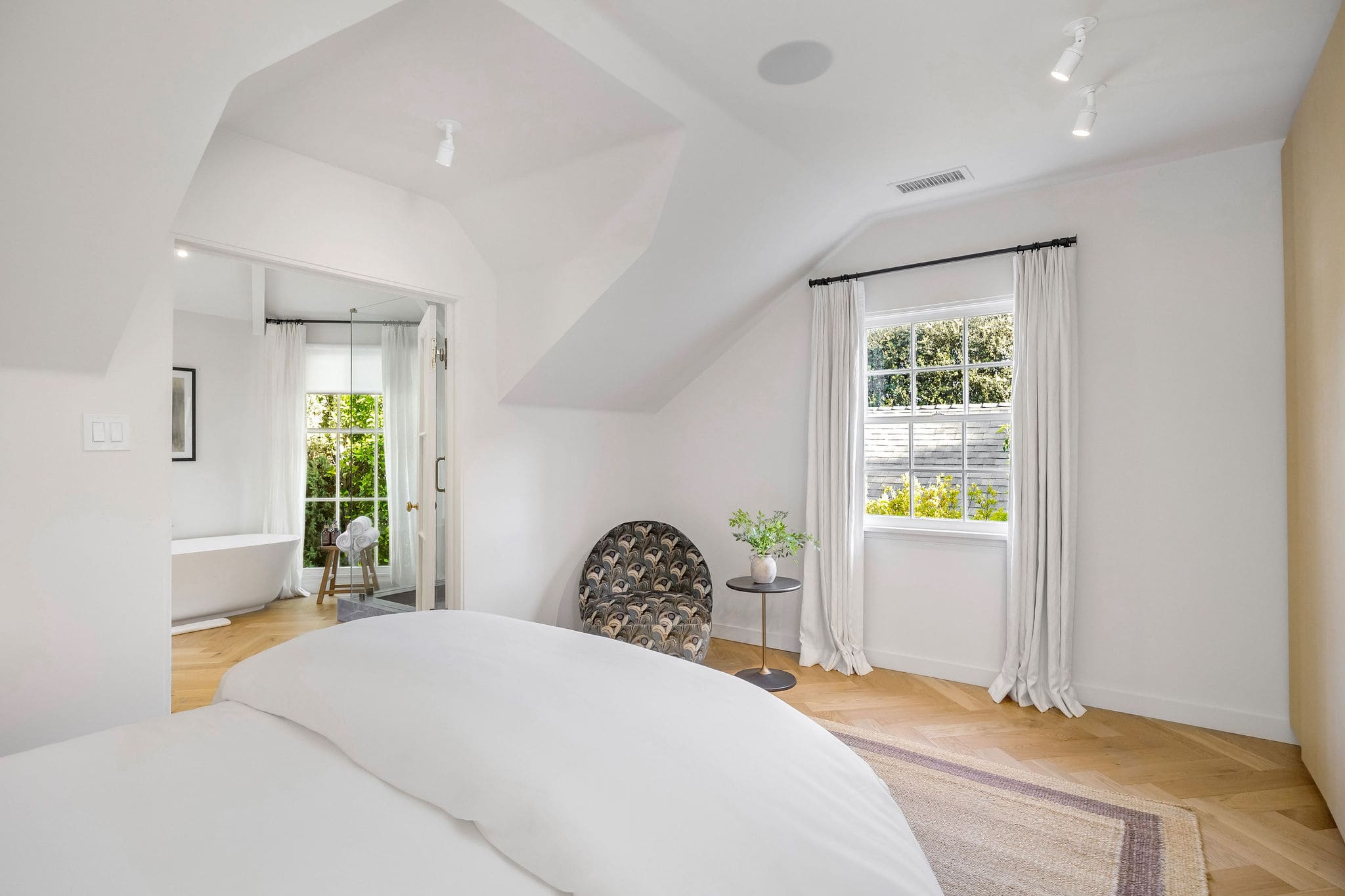 Soak in the freestanding tub while taking in peaceful garden views.