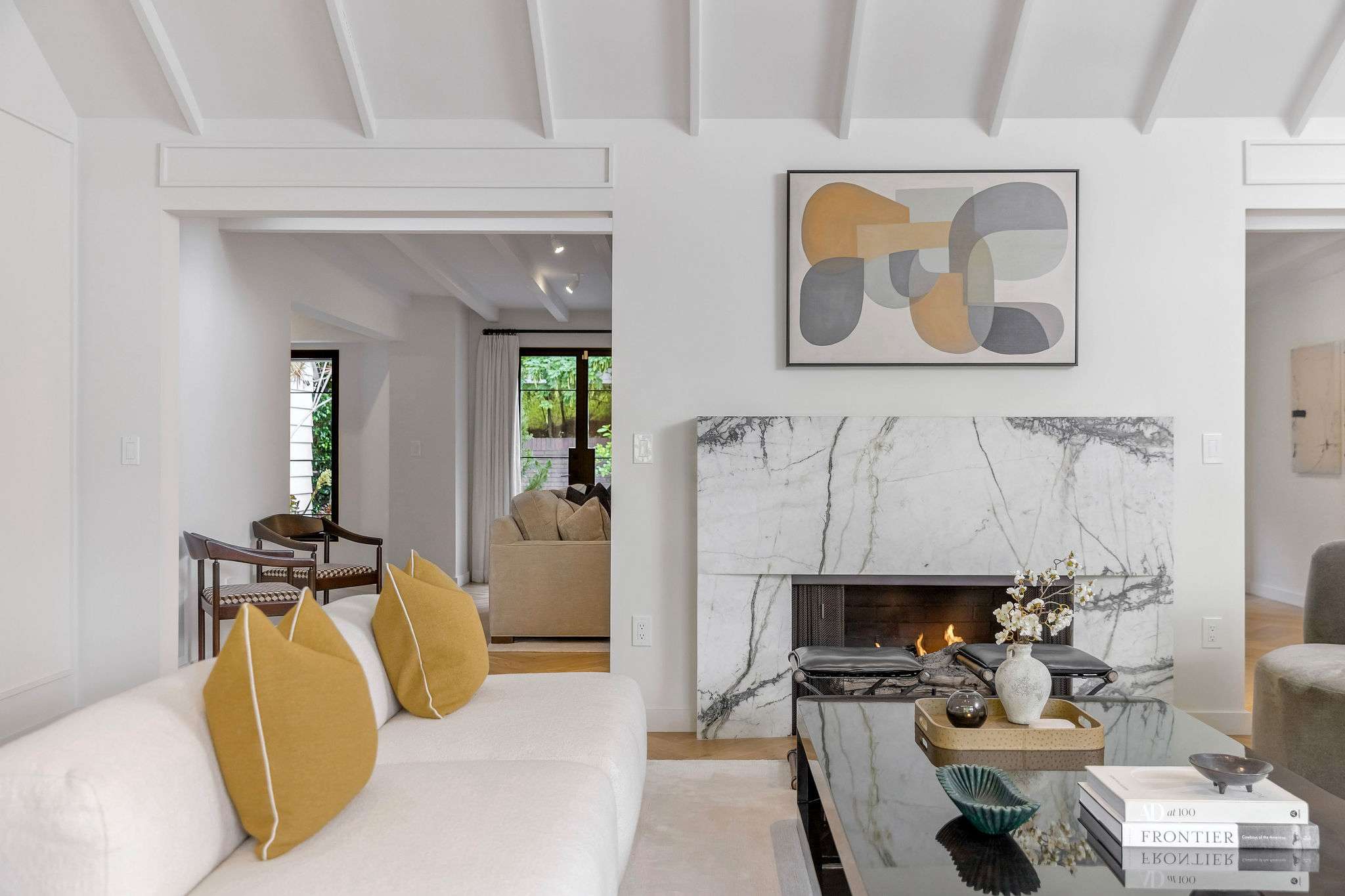 Cozy up by the marble fireplace after a day exploring Los Angeles.