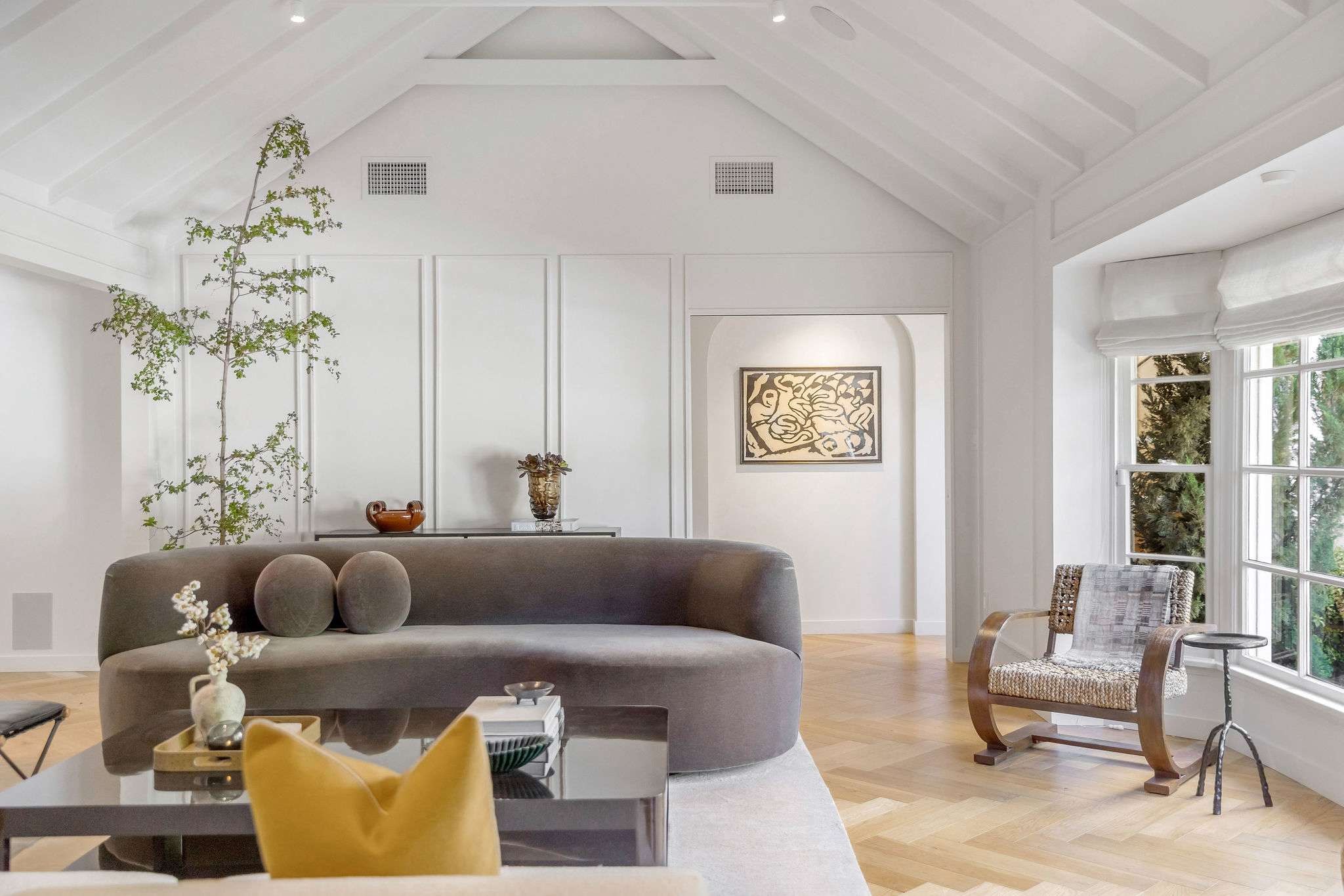 Gather beneath soaring vaulted ceilings designed for effortless living.