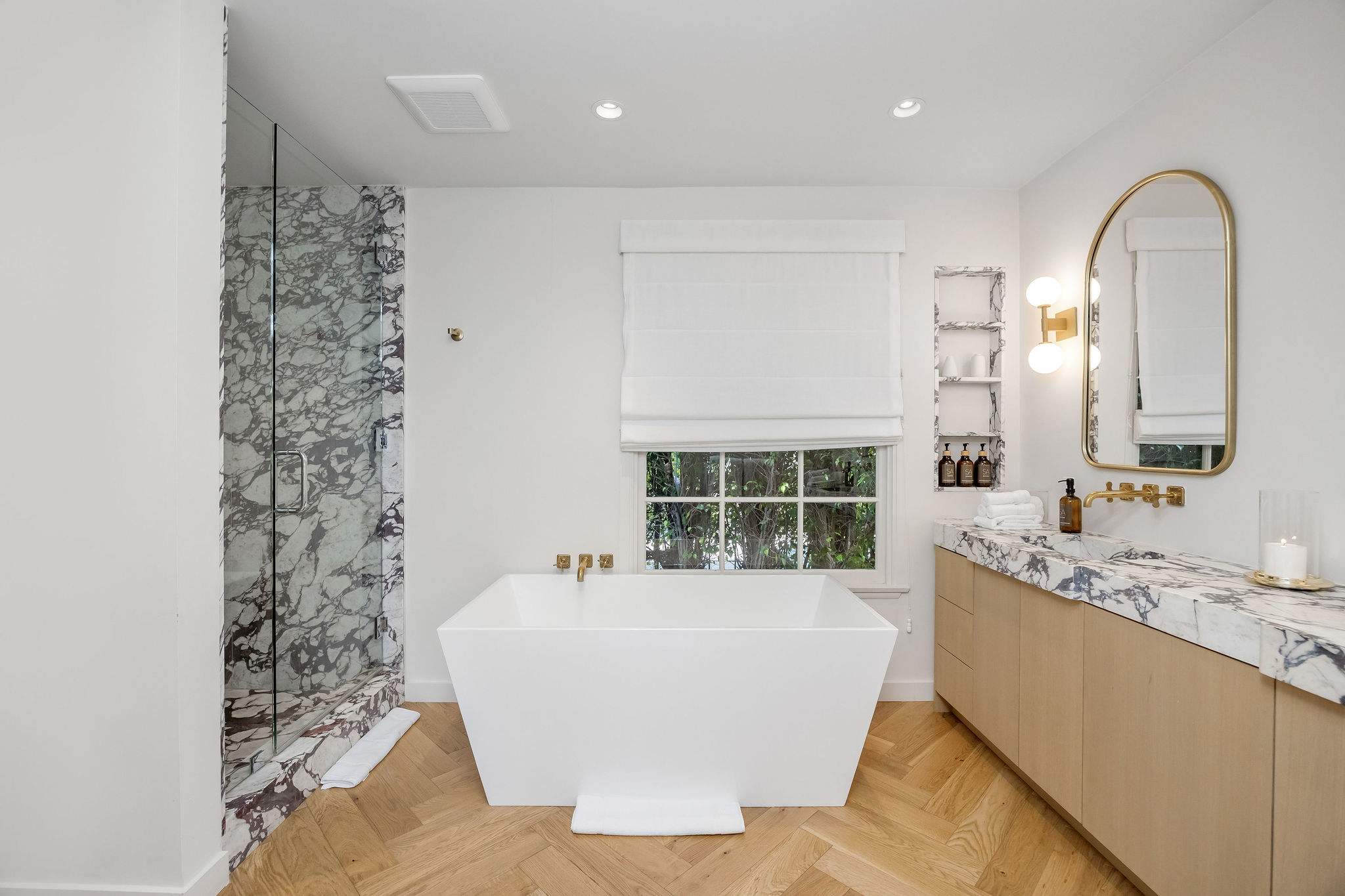 Indulge in a spa-inspired bath with a freestanding soaking tub.