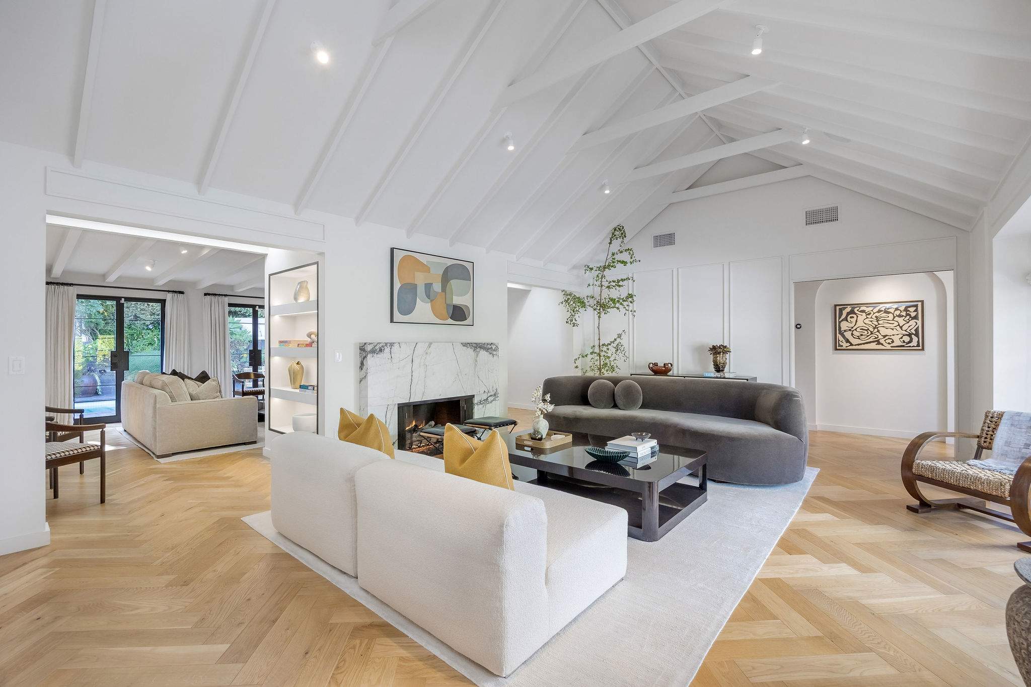 Gather beneath soaring ceilings in a living room designed for connection.