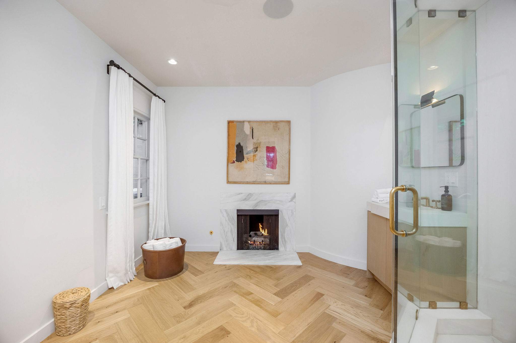 Enjoy slow mornings beside the fireplace and oversized glass shower.