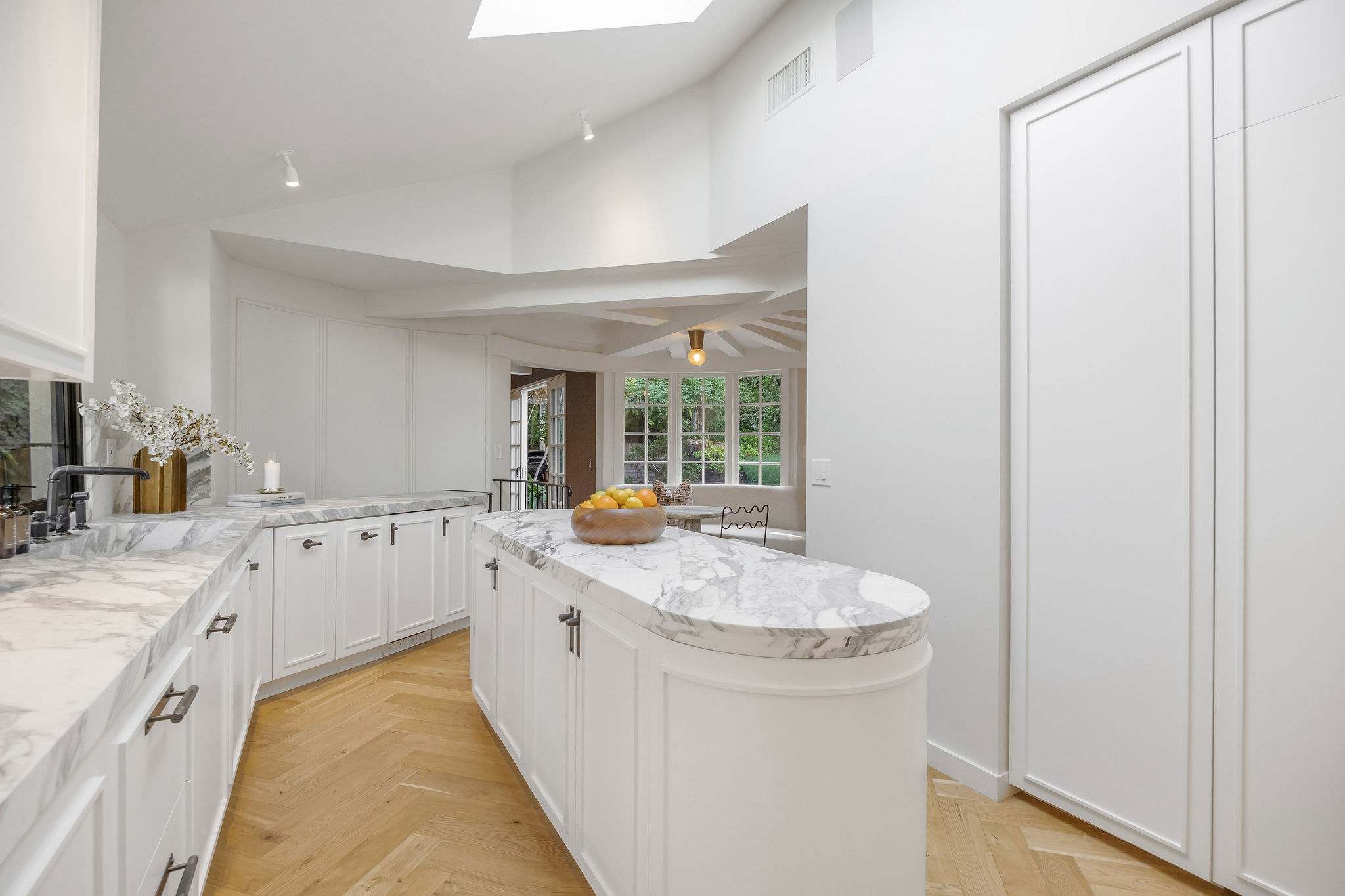 Prepare memorable meals in a marble-clad chef's kitchen designed for gathering.