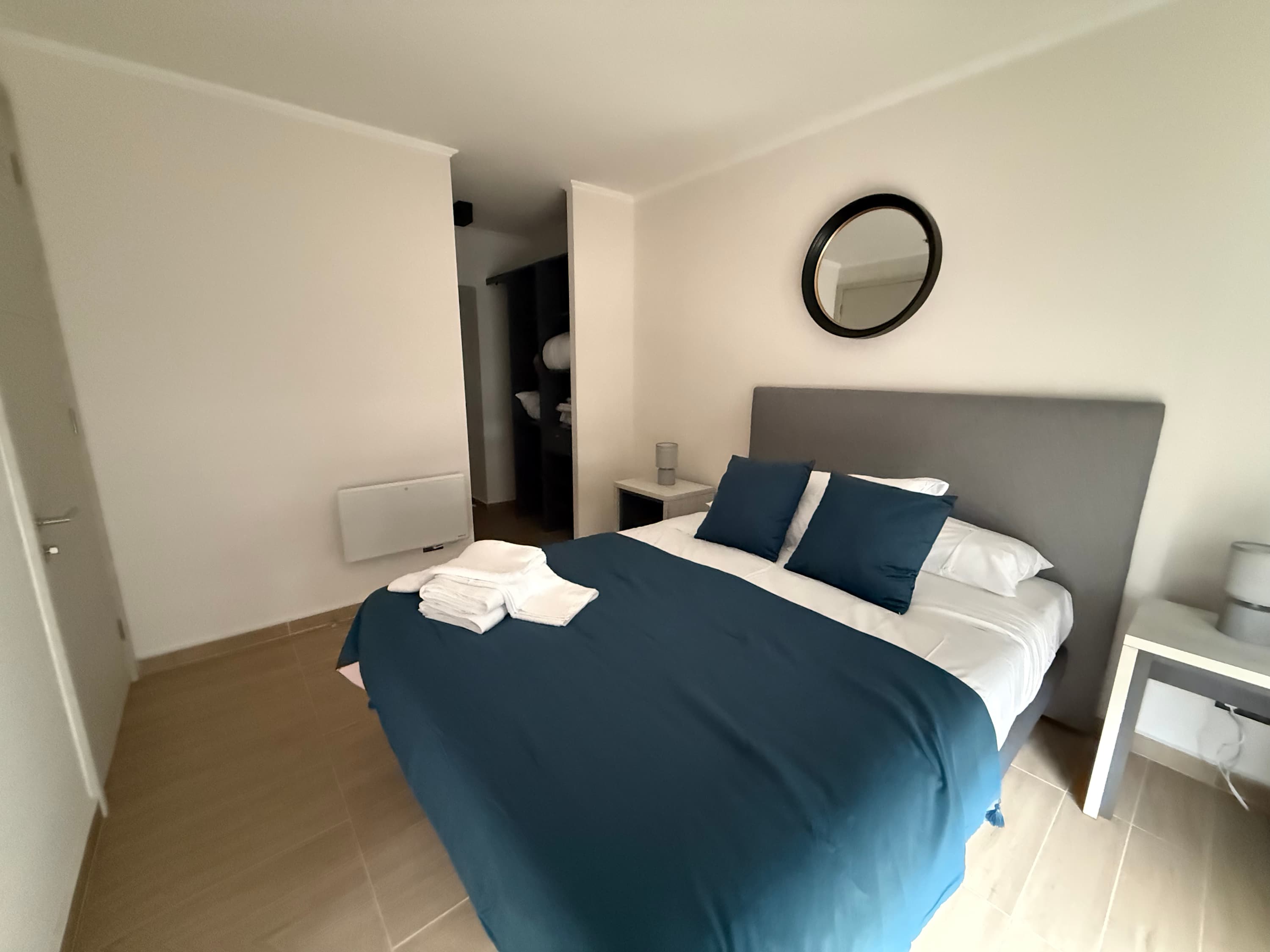 Cozy bedroom with modern decor and plush bedding, perfect for a restful night's sleep.