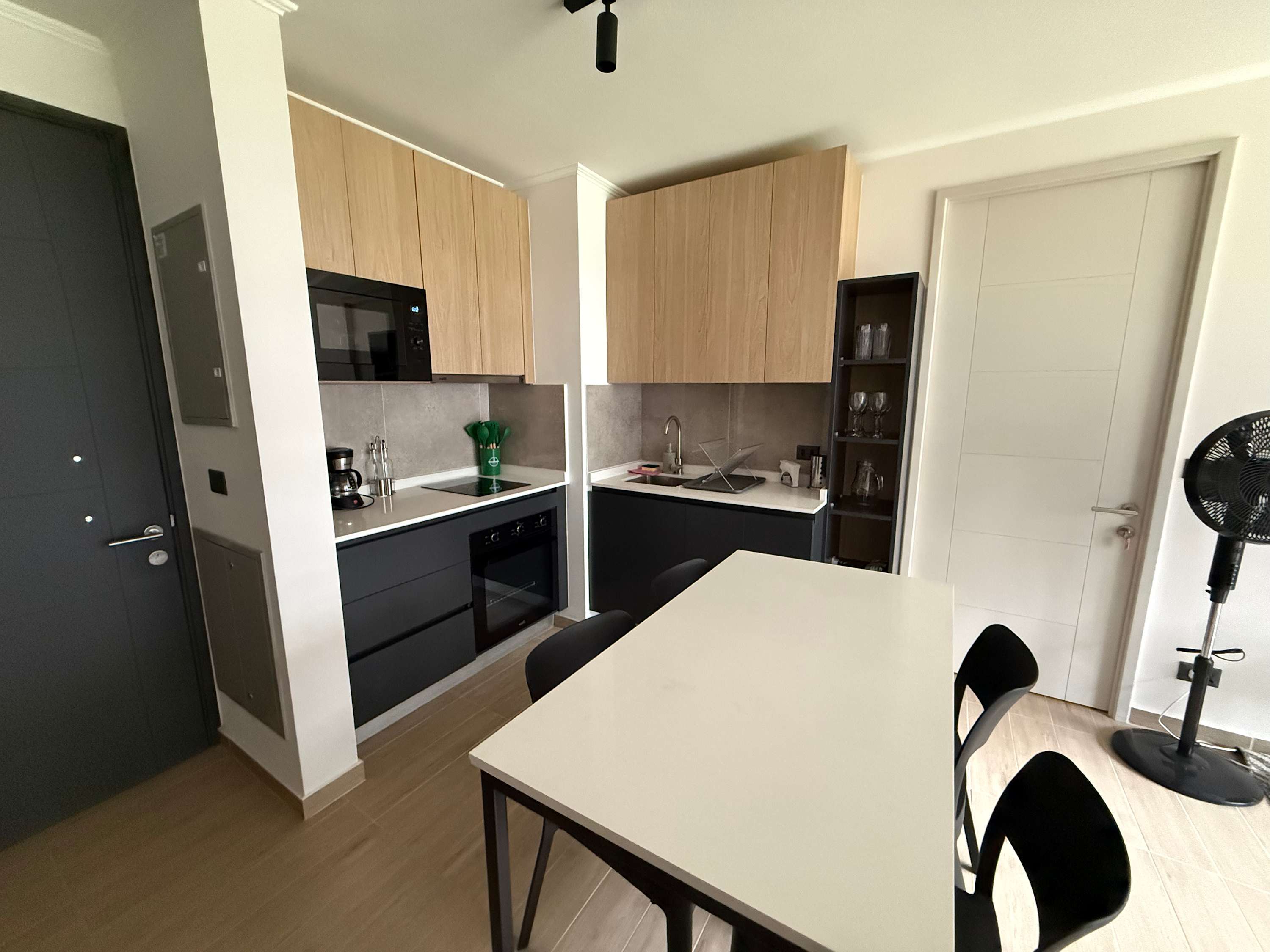 Modern kitchen with sleek design and ample seating, perfect for enjoying meals and gatherings.