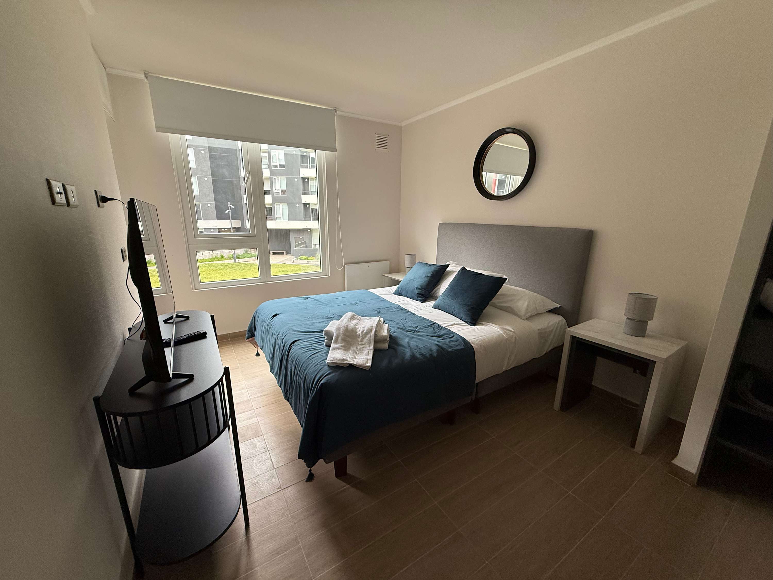 Relax in this cozy bedroom with a plush bed and natural light, perfect for unwinding after a day of exploring.