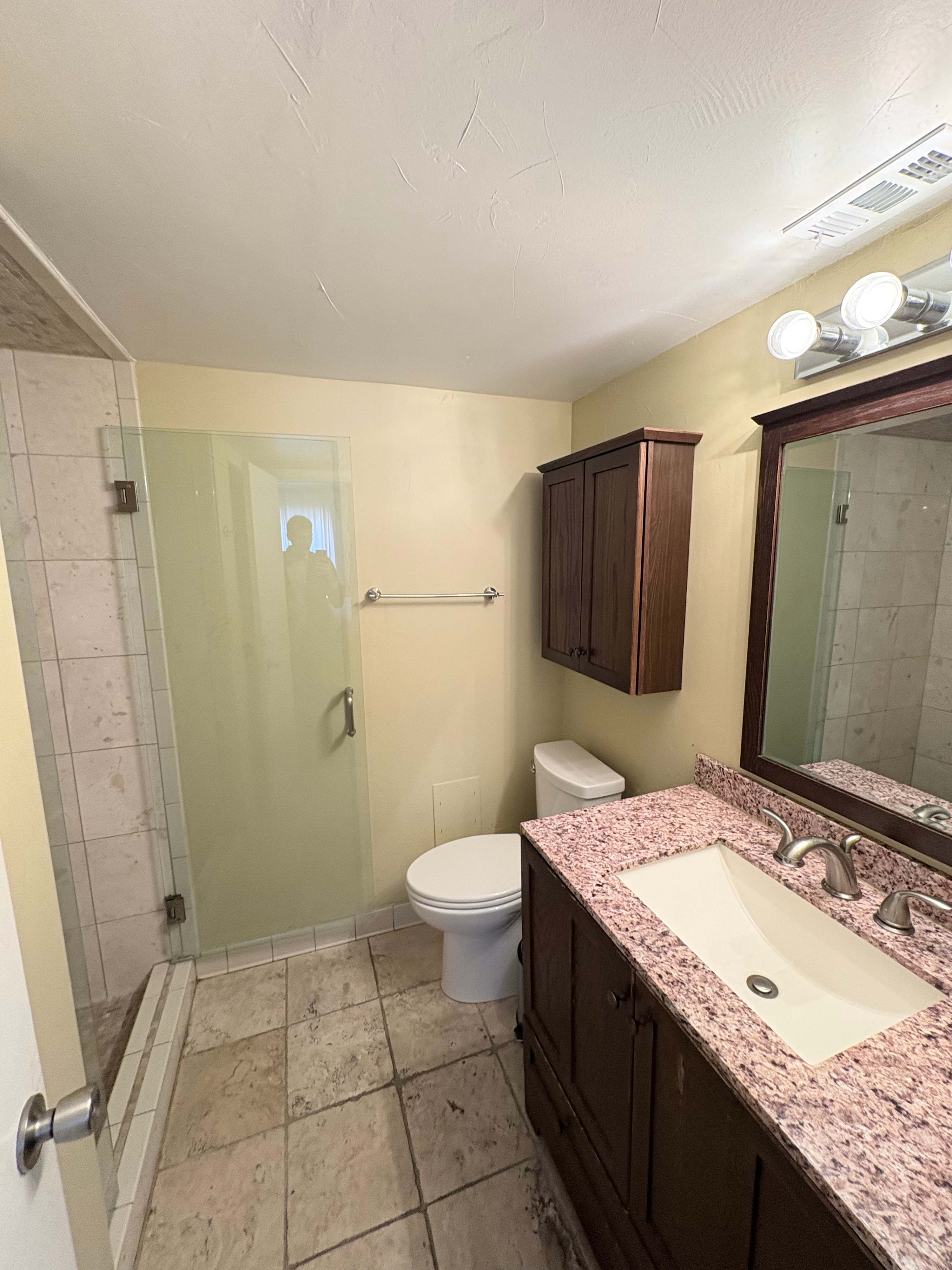 Refresh in the stylish bathroom featuring an expansive vanity and modern fixtures.